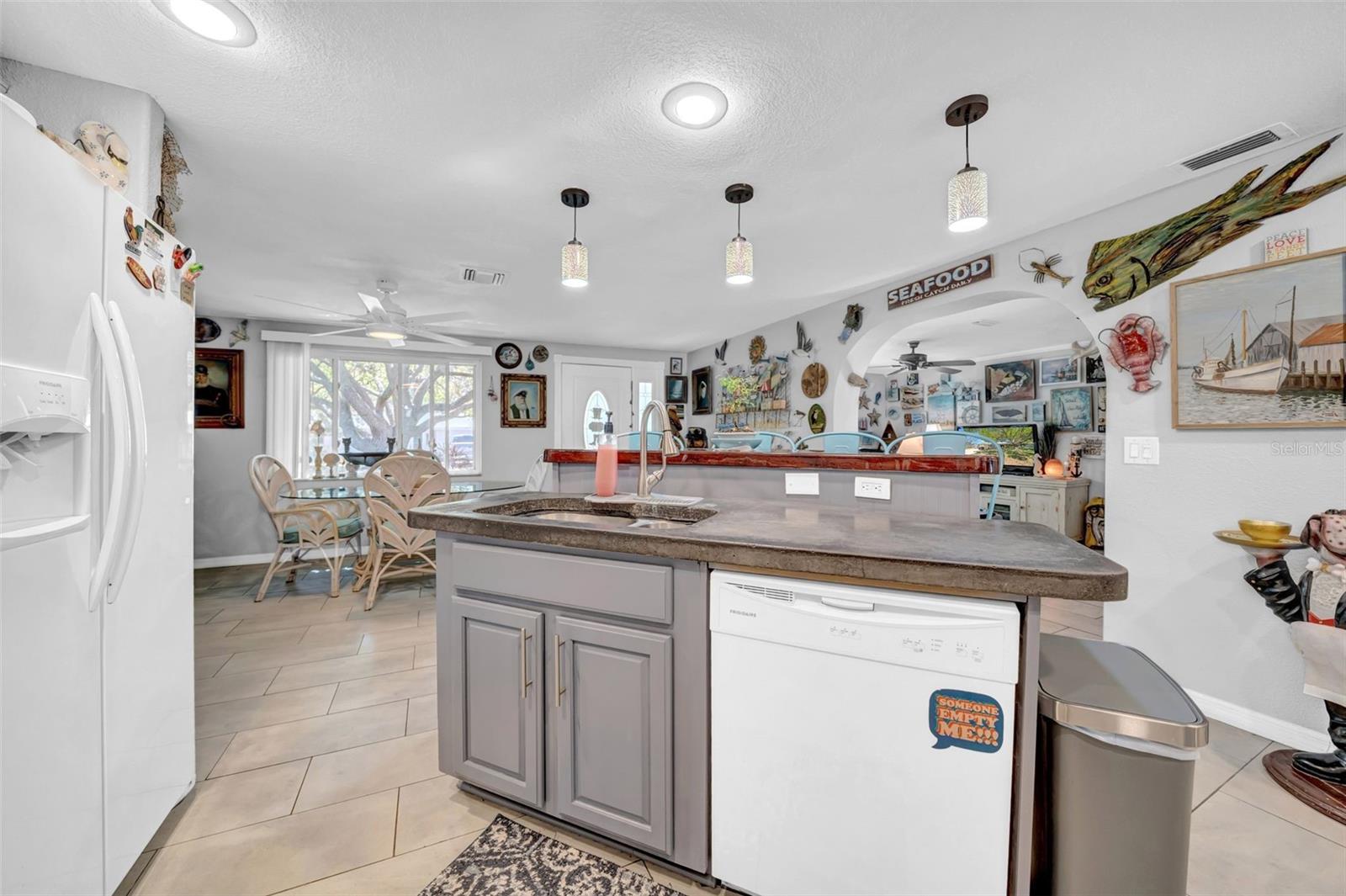 Chef's dliight with this open concept kitchen!  Concrete & wood counters, new dishwasher and stove, professionally lacquered cabinets and so much more, new light fixtures, new tap, and so much more!