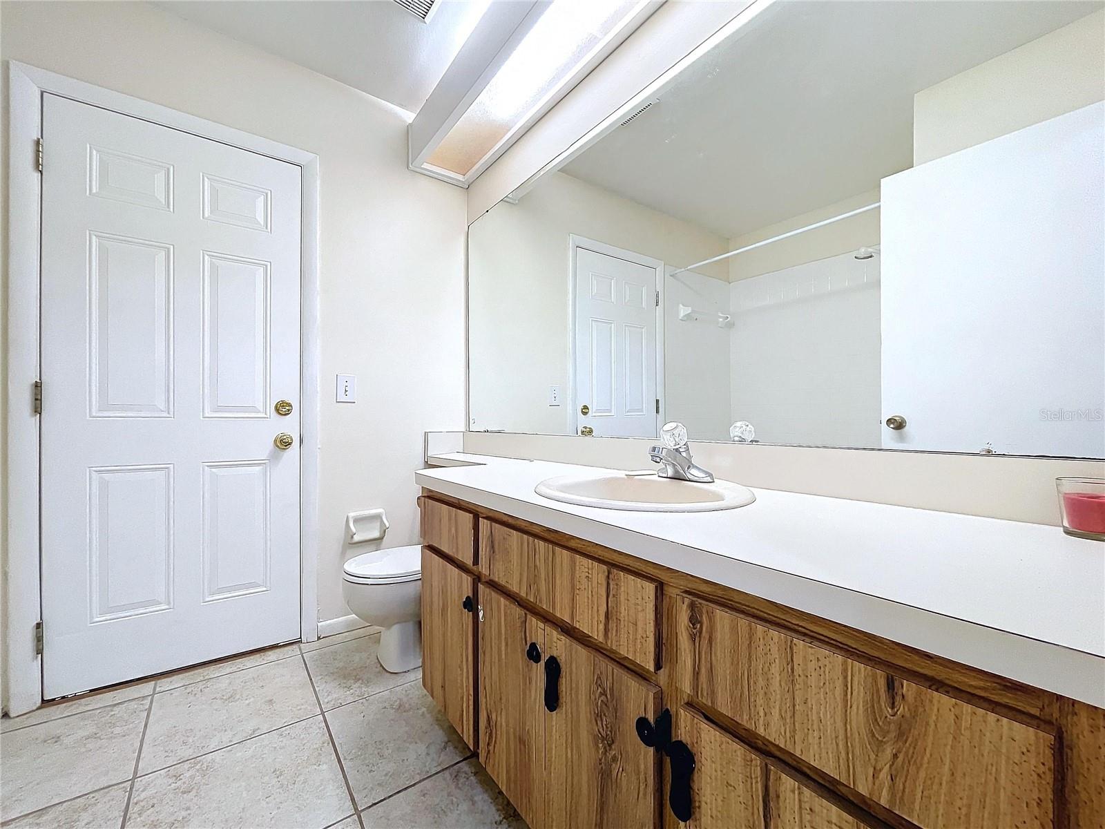 Hall Bath with door to screen porch and large vanity