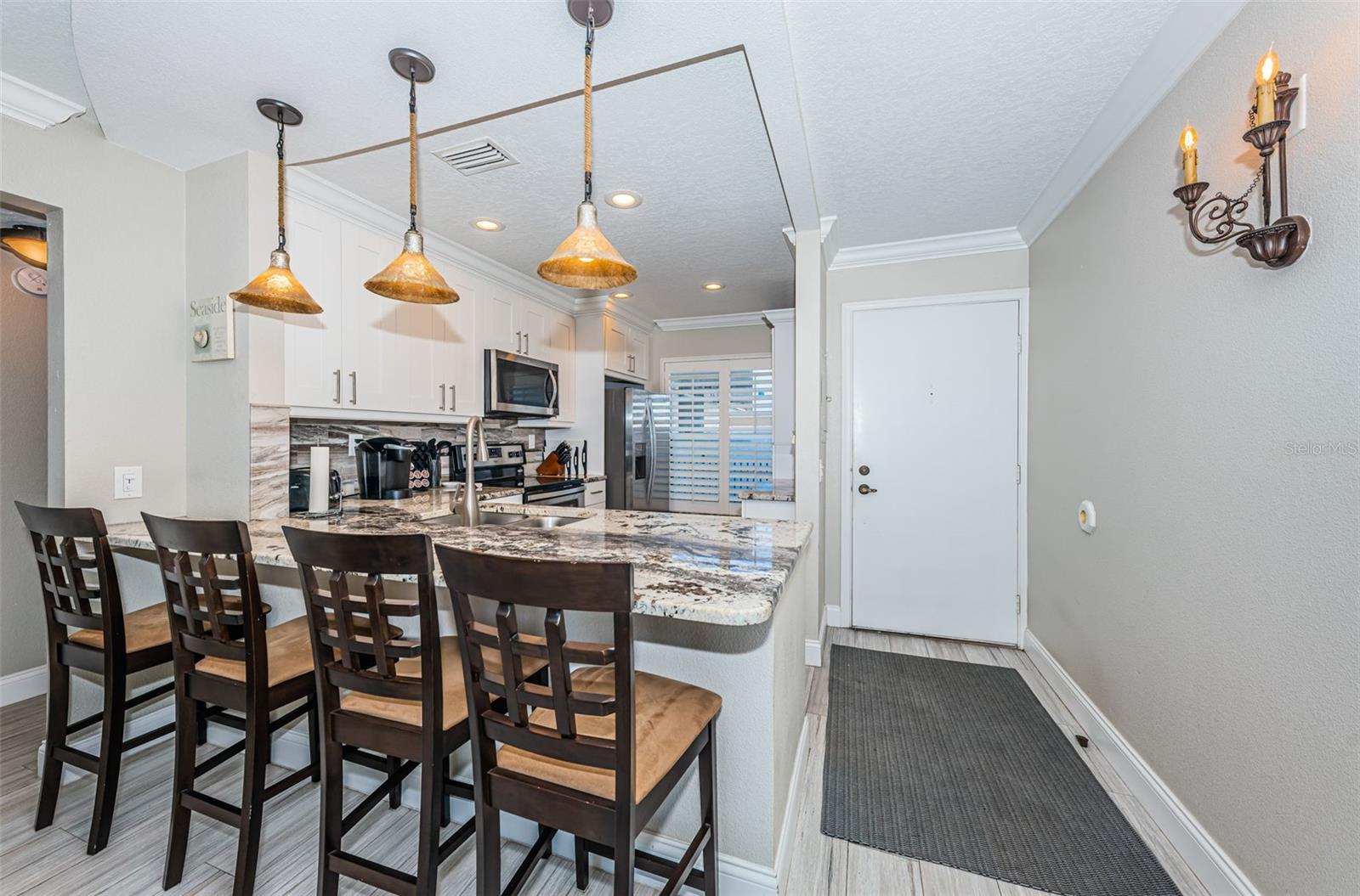 View to Entryway and Kitchen - Lots of Seating at Extended Countertop