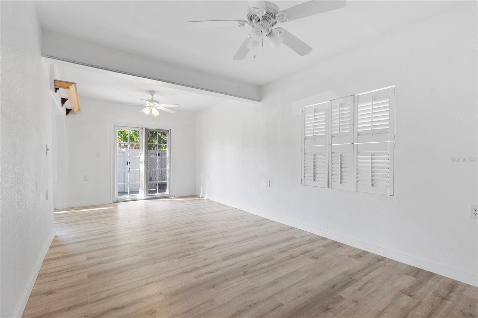 Dining Room. Doors, with screens, open to the fenced, back yard.