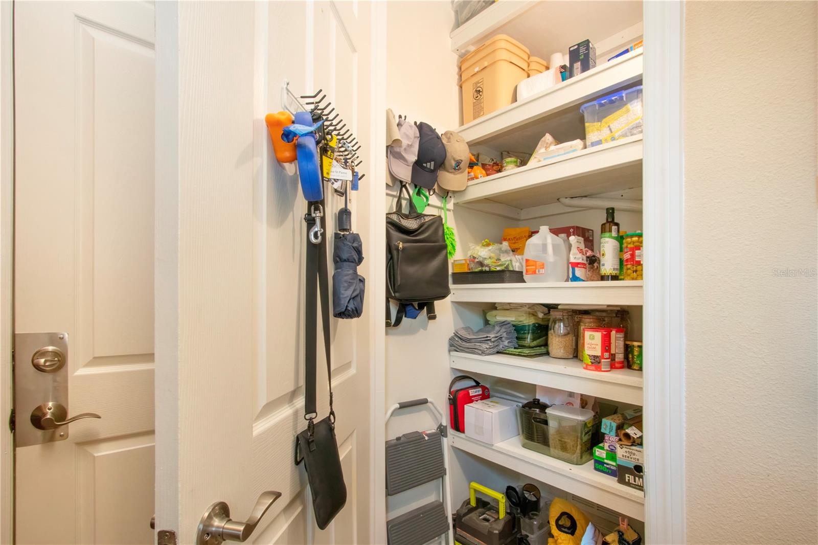 Newly created laundry room pantry w/ floor to ceiling shelves