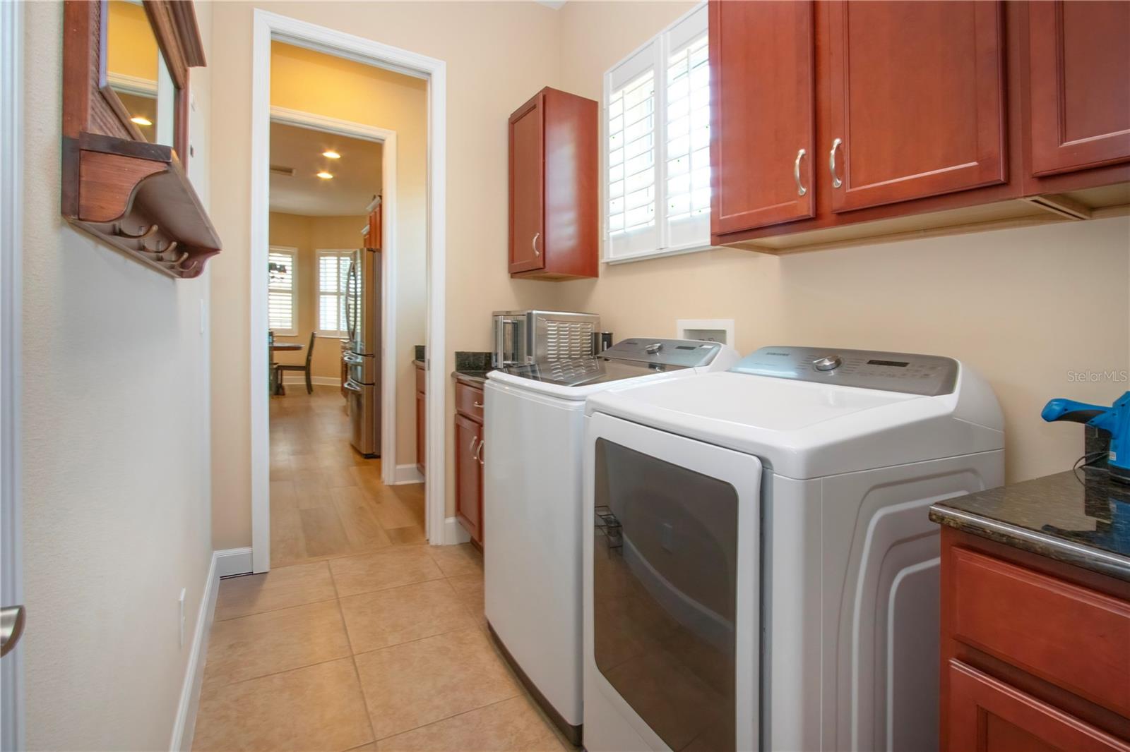 Inside Utility Room w/washer & gas dryer & lots of storage cabinets