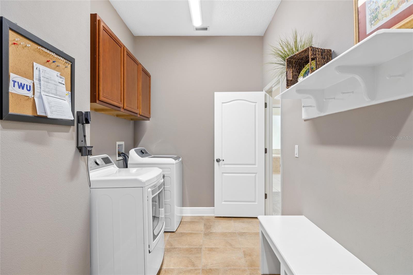 Oversized laundry room that connects the garage and master closet