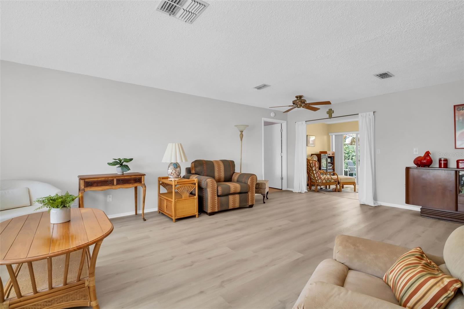 Lovely light toned luxury vinyl flooring throughout the spacious main living area.~