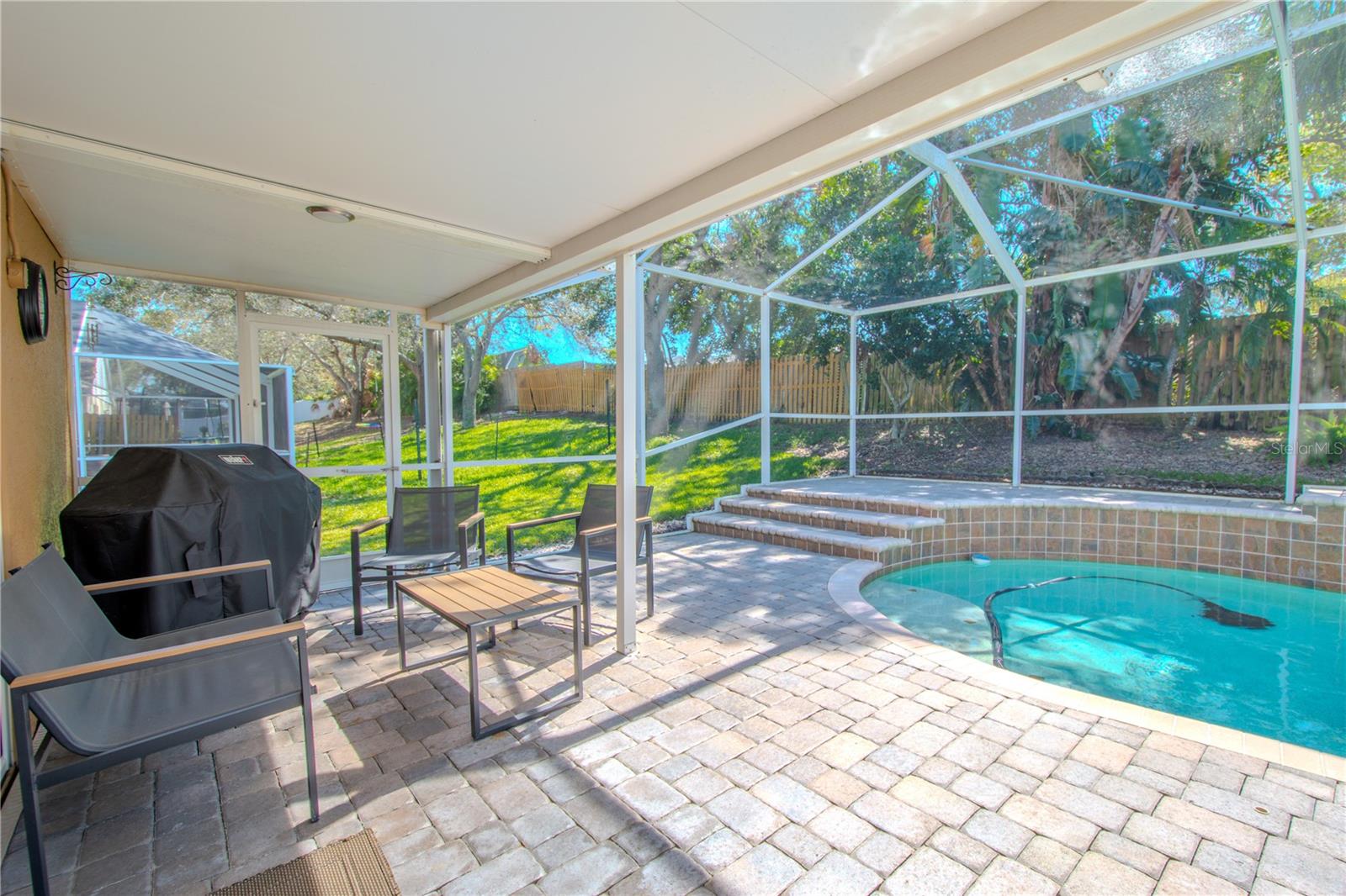 The screened in lanai has a pavered pool deck as well as areas fo both shade and sun.