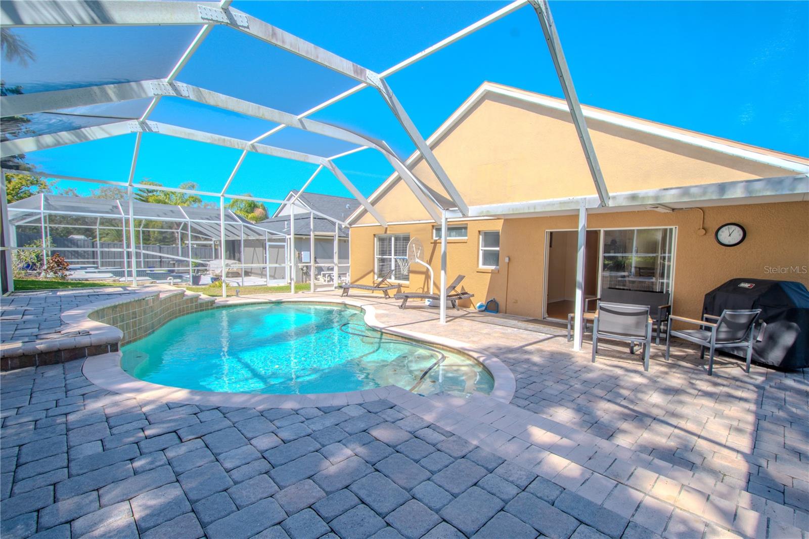 The lanai features a covered patio ideal for dining al fresco and cookouts