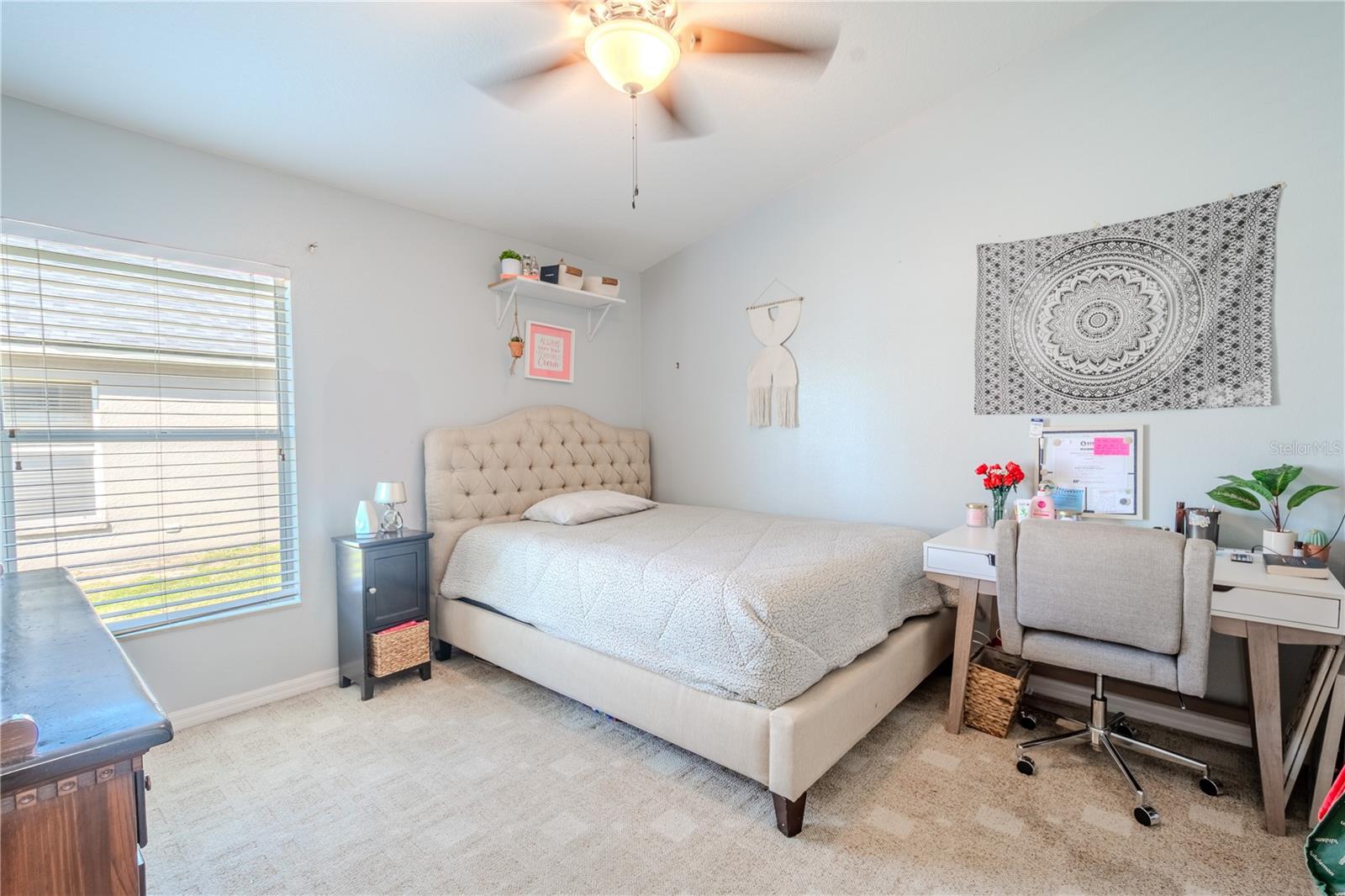 Bedroom 3 features neutraal tone carpet, a ceiling fan with light kit and a built in closet.