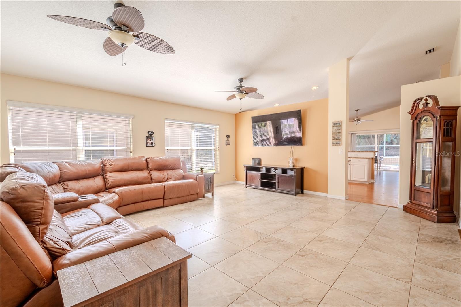 The living room features easy-to-maintain tile floor, vaulted ceilings and 2 ceiling fans with light kits.