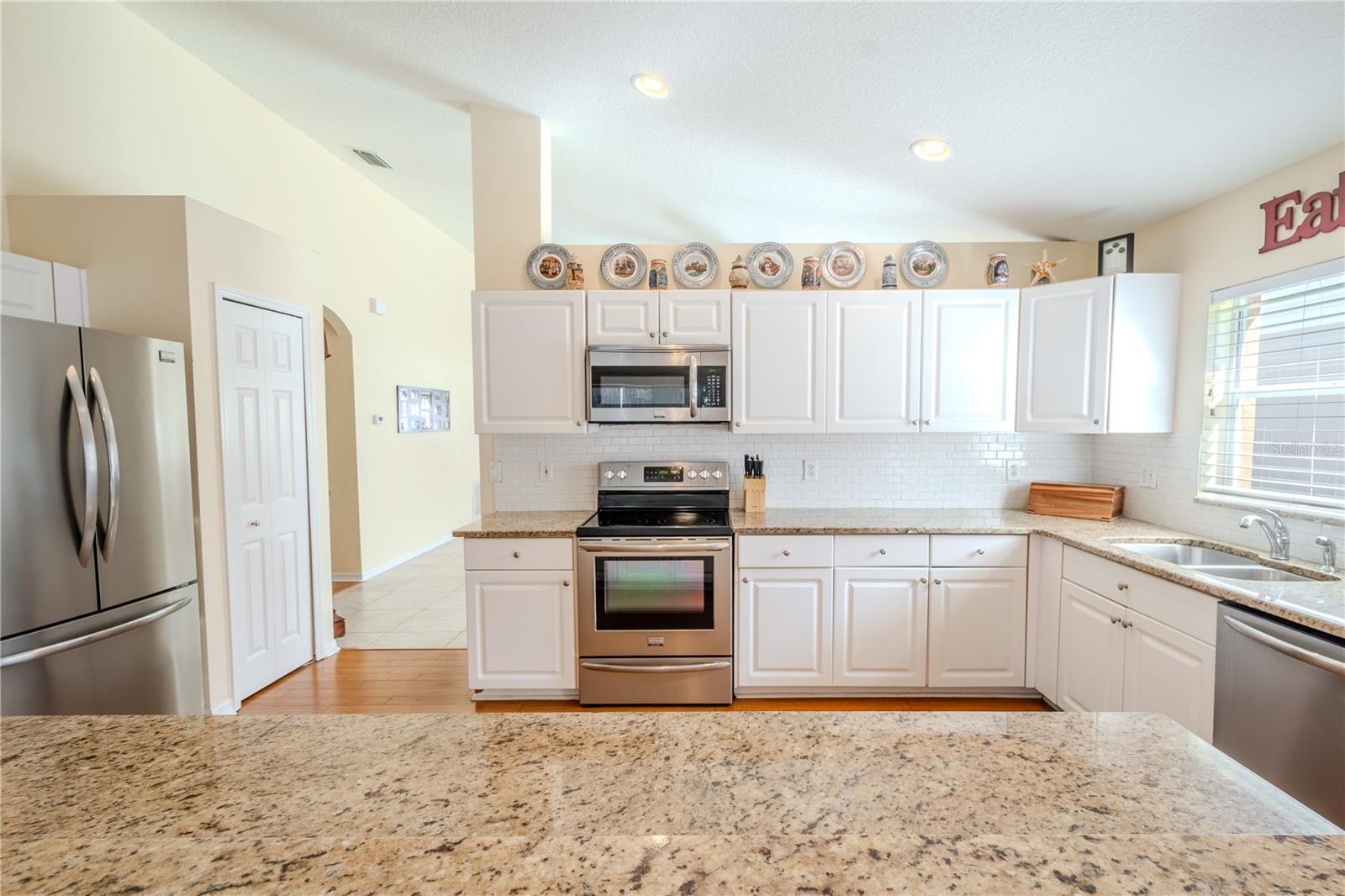 The kitchen features a French door refrigerator, cooktop range, microwave and dishwasher. (2016)