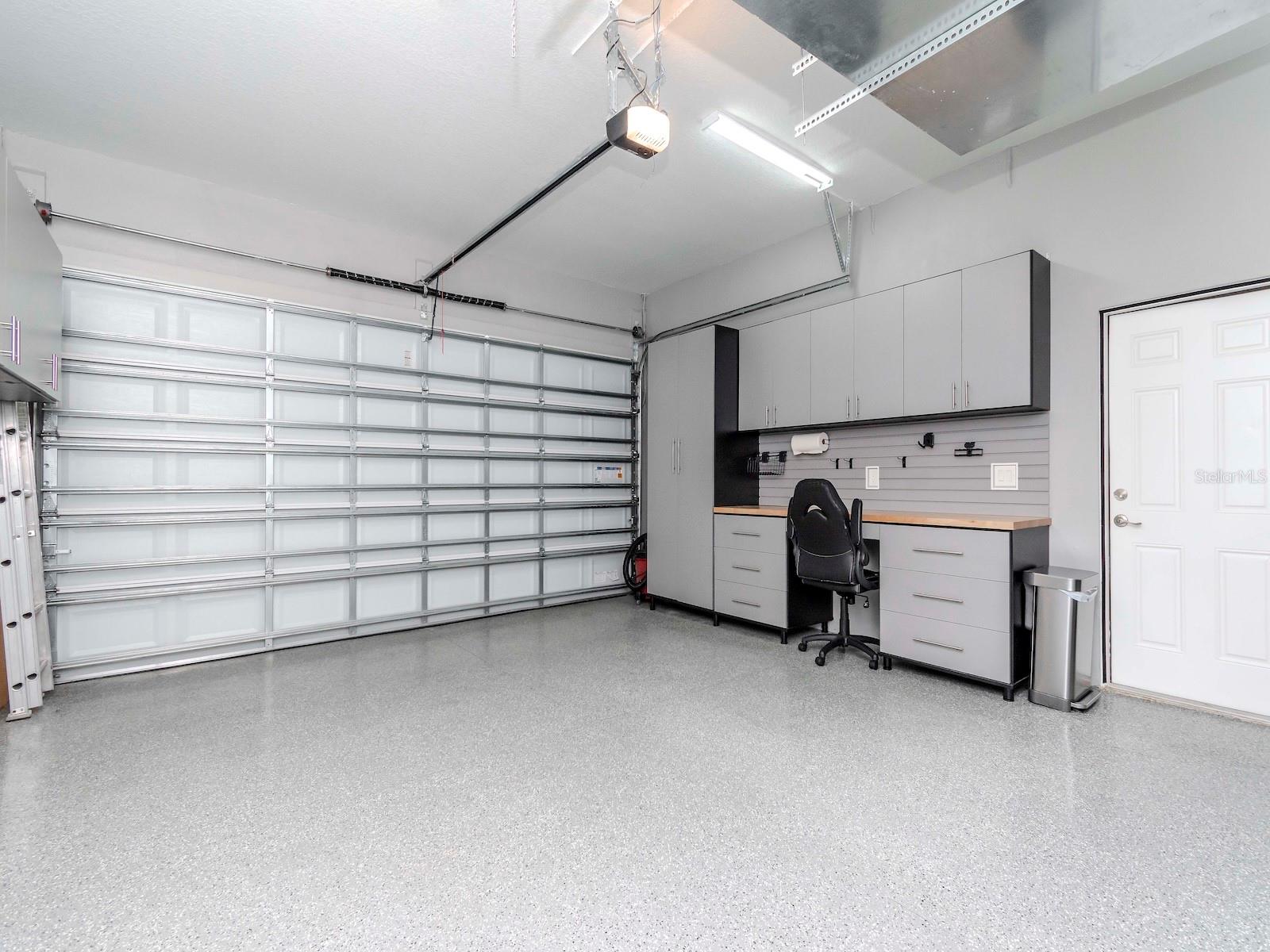 2 CAR ATTACHED GARAGE WITH EPOXY FLOORS & CABINETS AND WORK BENCH