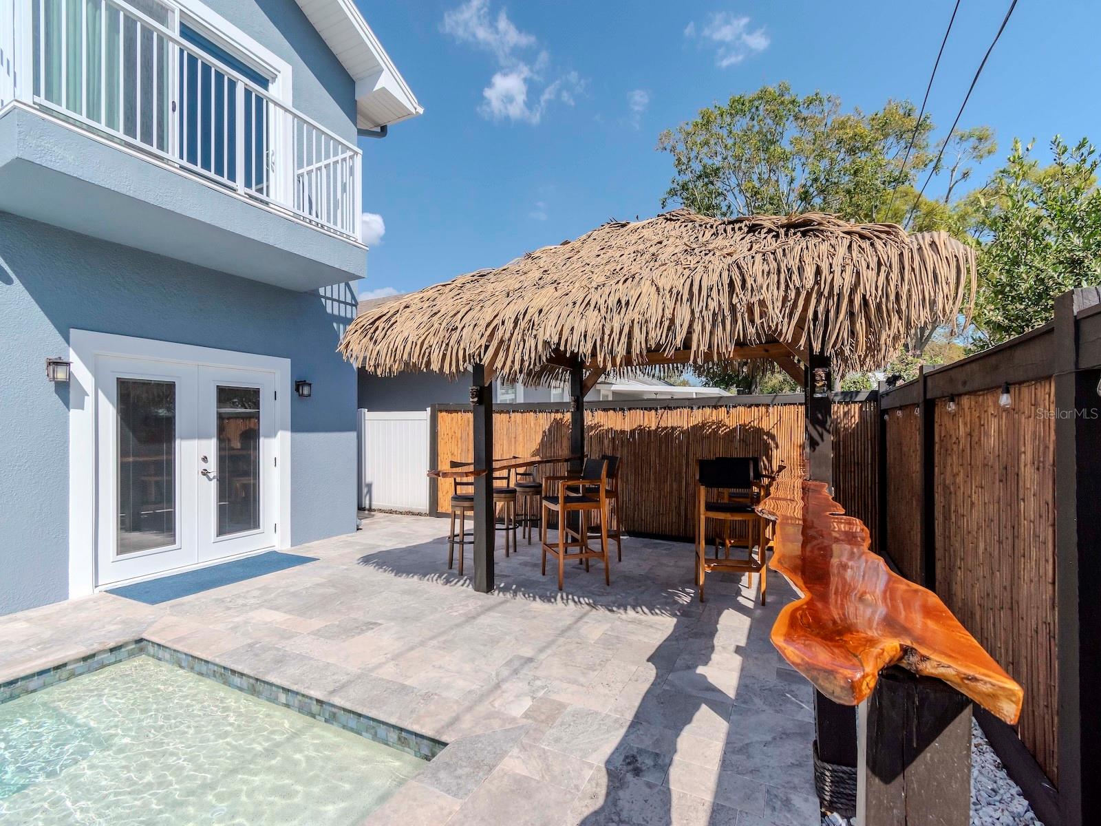 BACK YARD WITH TIKI BAR AND SALT WATER POOL