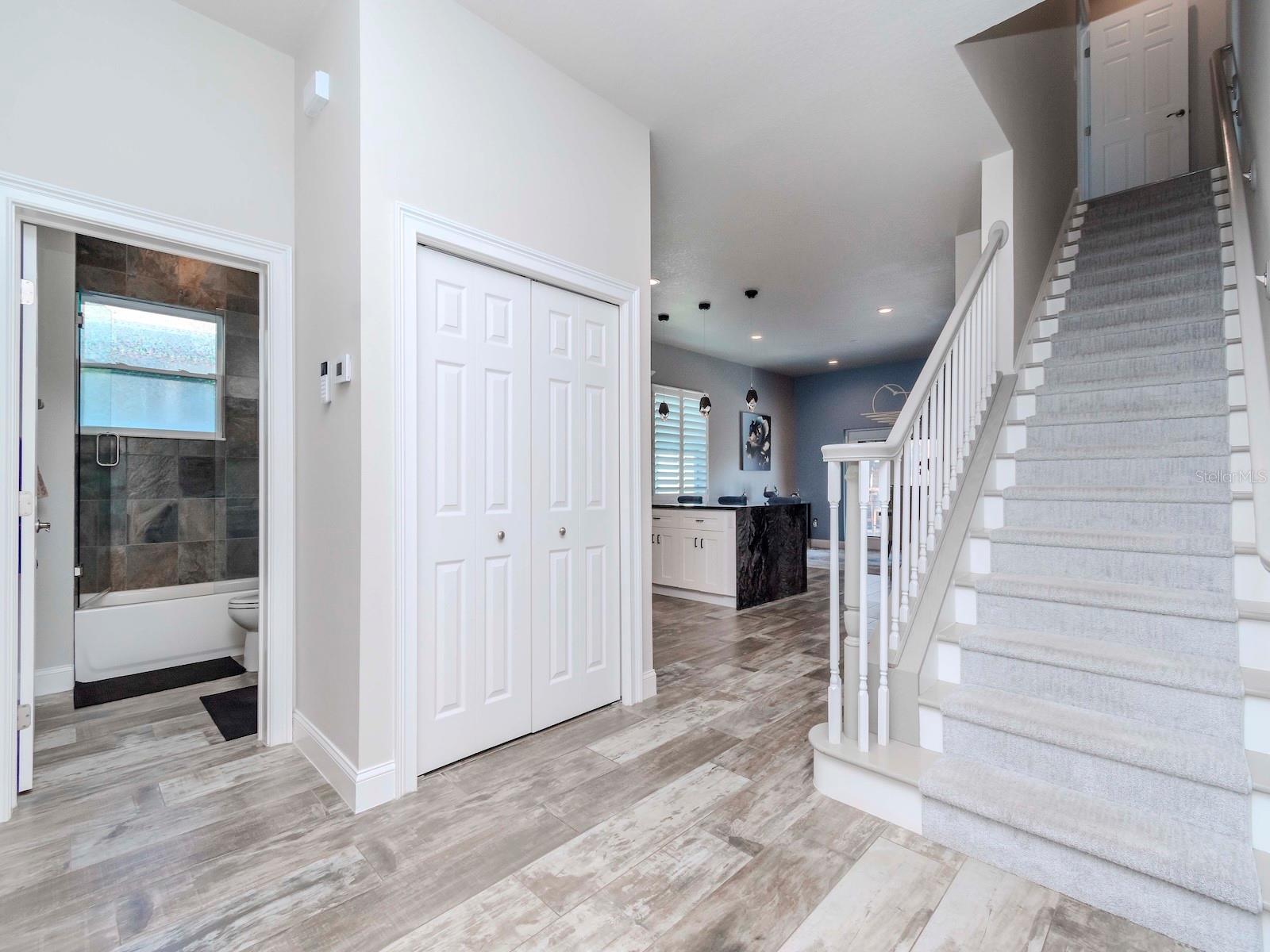 THROUGH LIVING ROOM TO STEPS TO MASTER SUITE, BATHROOM 2 AND 2ND BEDROOM