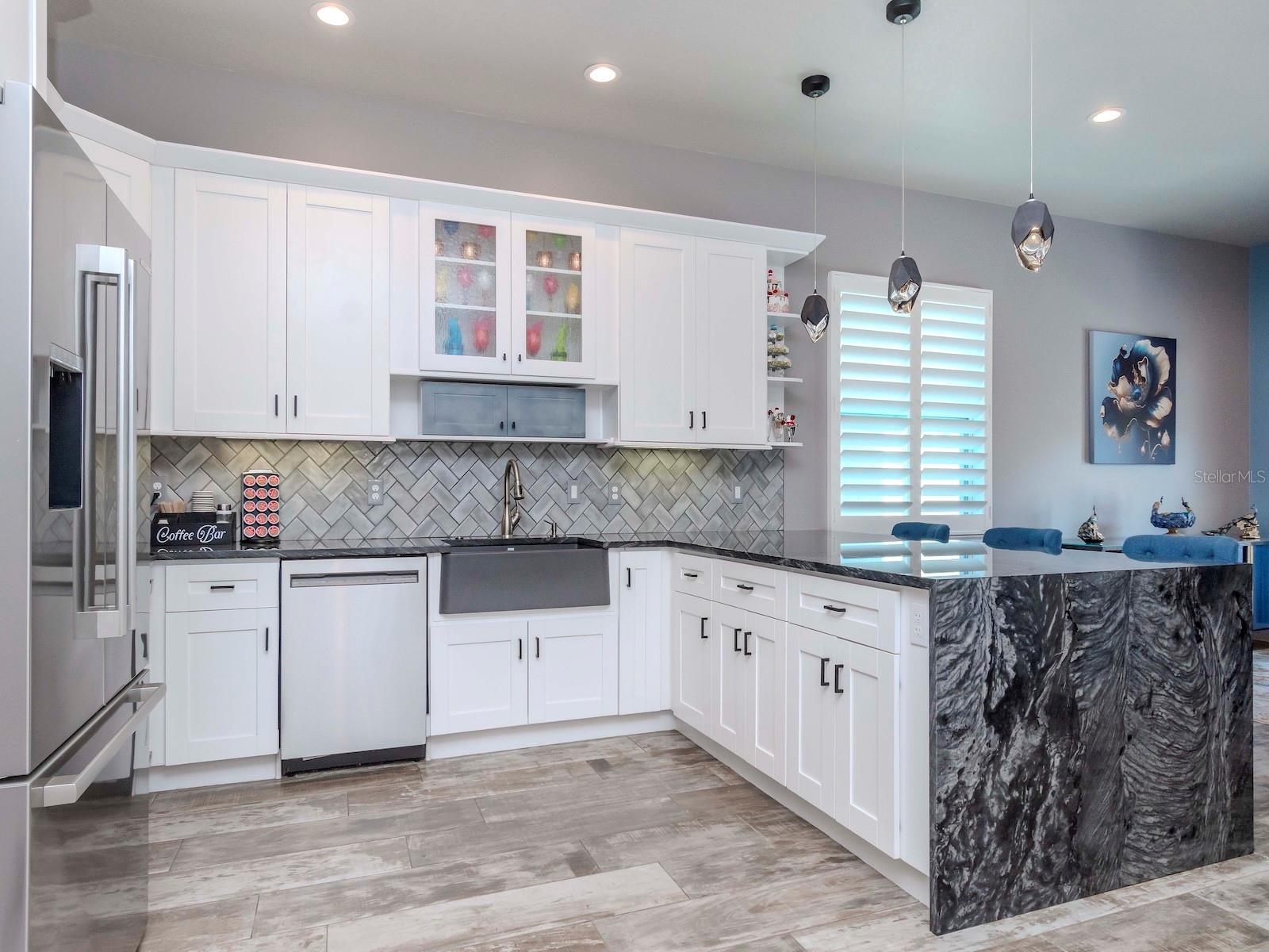 GOURMET KITCHEN W/ GRANITE WATERFALL COUNTERTOPS