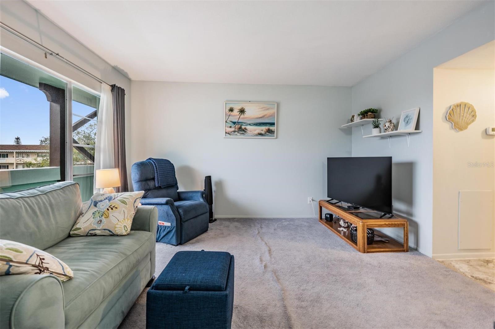 Living room at the front of the home with large picture windows.