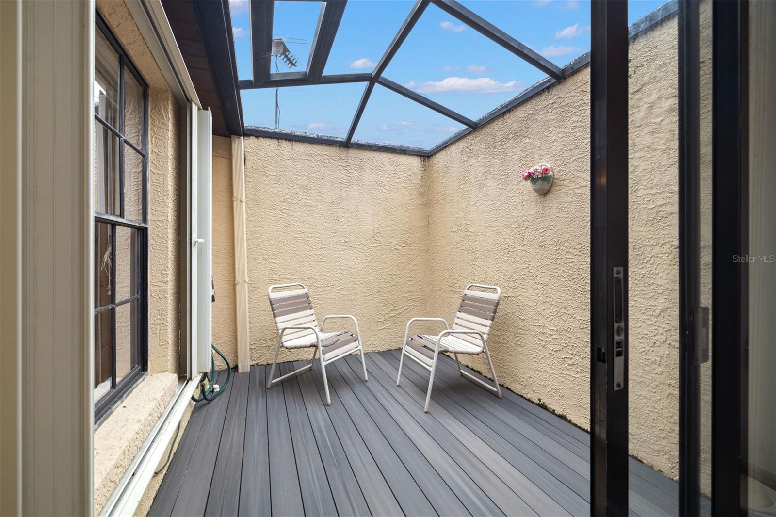 Screened-in enclosed, private courtyard.  Features new flooring. Perfect for a little private sunshine!