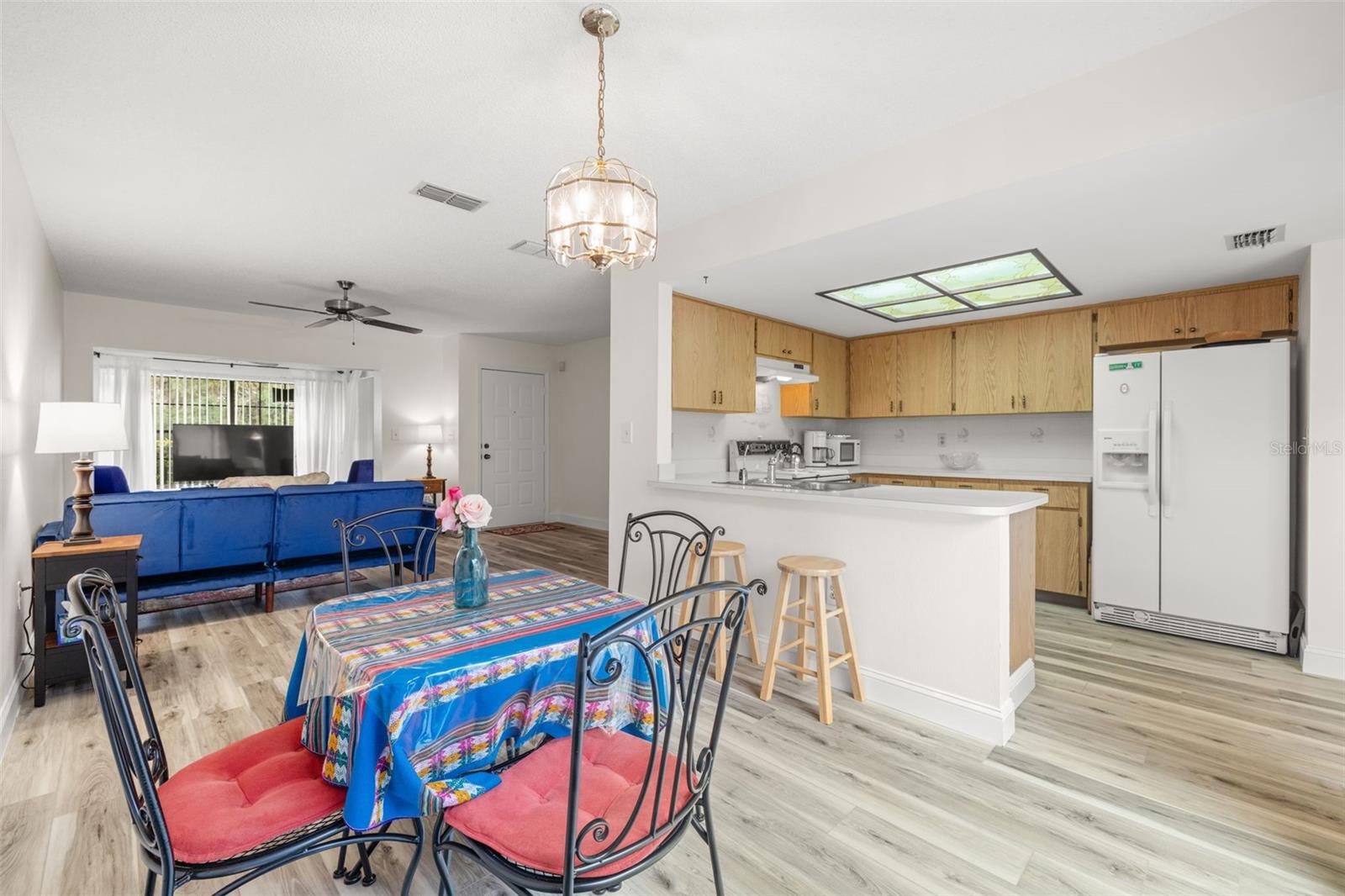 View from the dining room, into the kitchen and living areas.