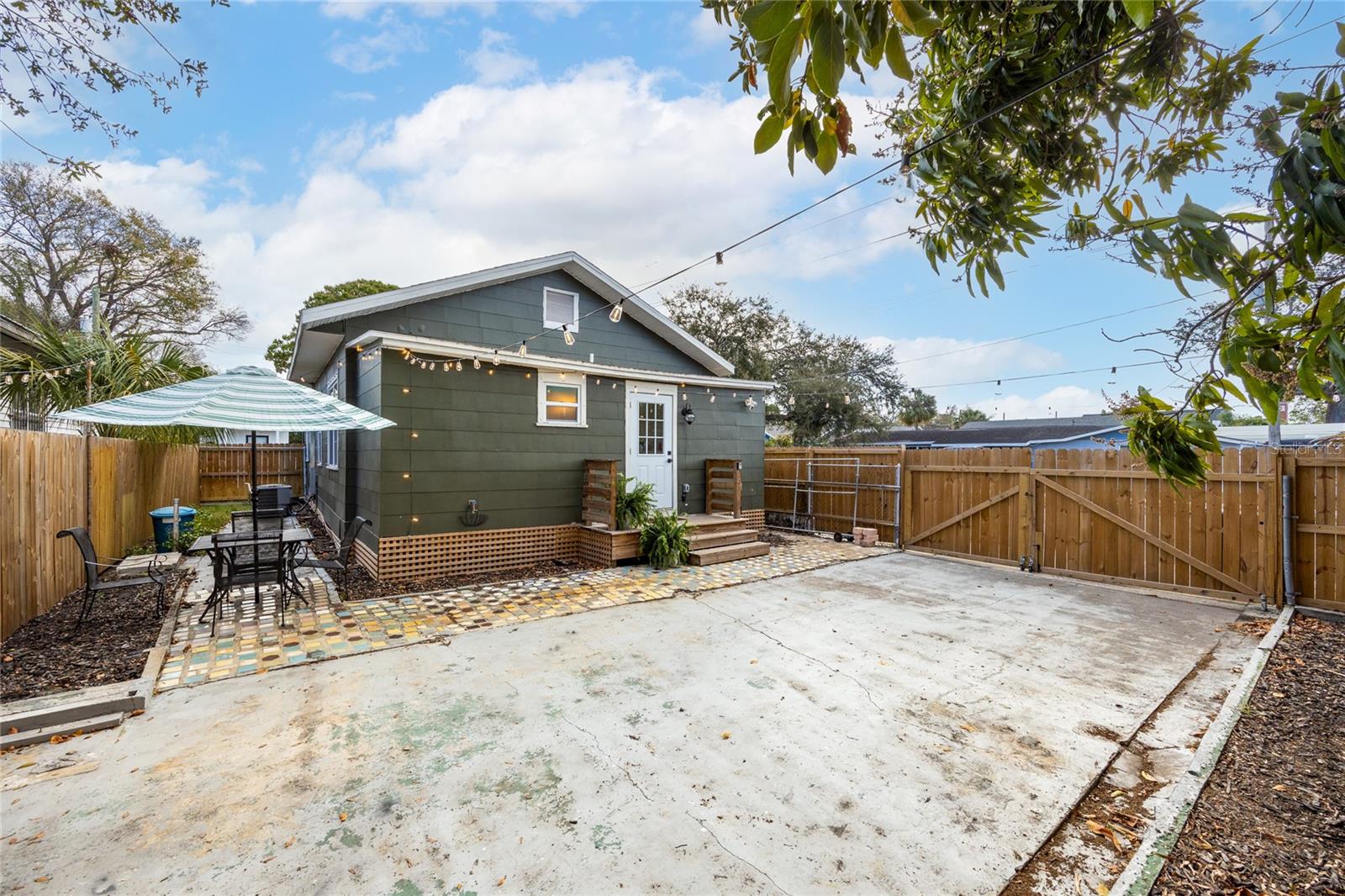 private backyard, fully fenced with parking pad