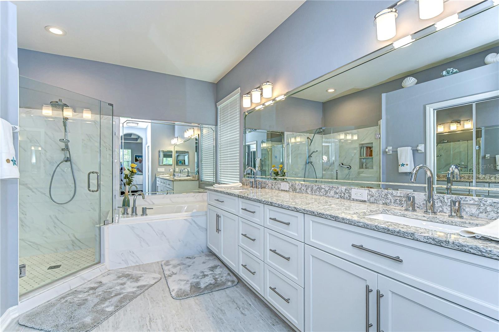 This elegant bathroom oasis features ample space and dual sinks!