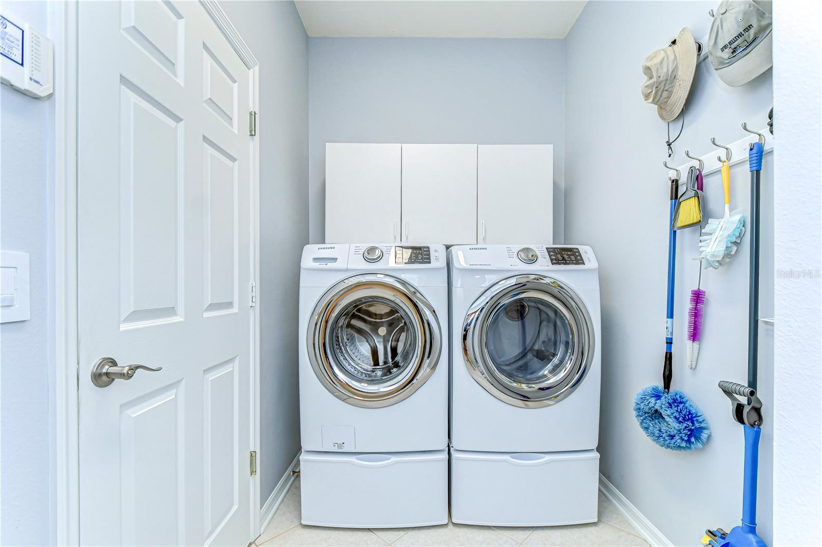 Transform laundry day from chore to delight in this bright, organized utility room featuring modern appliances and ample storage.