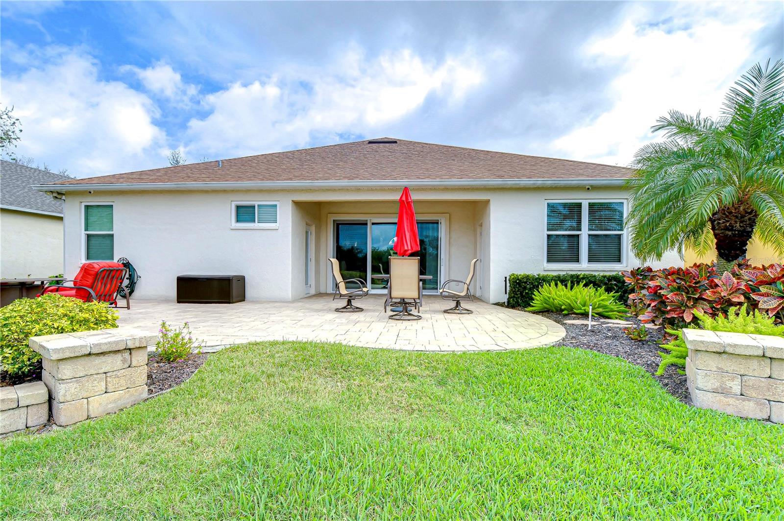 Enjoy seamless indoor-outdoor living with this charming patio, perfect for alfresco dining or lounging under the sun.