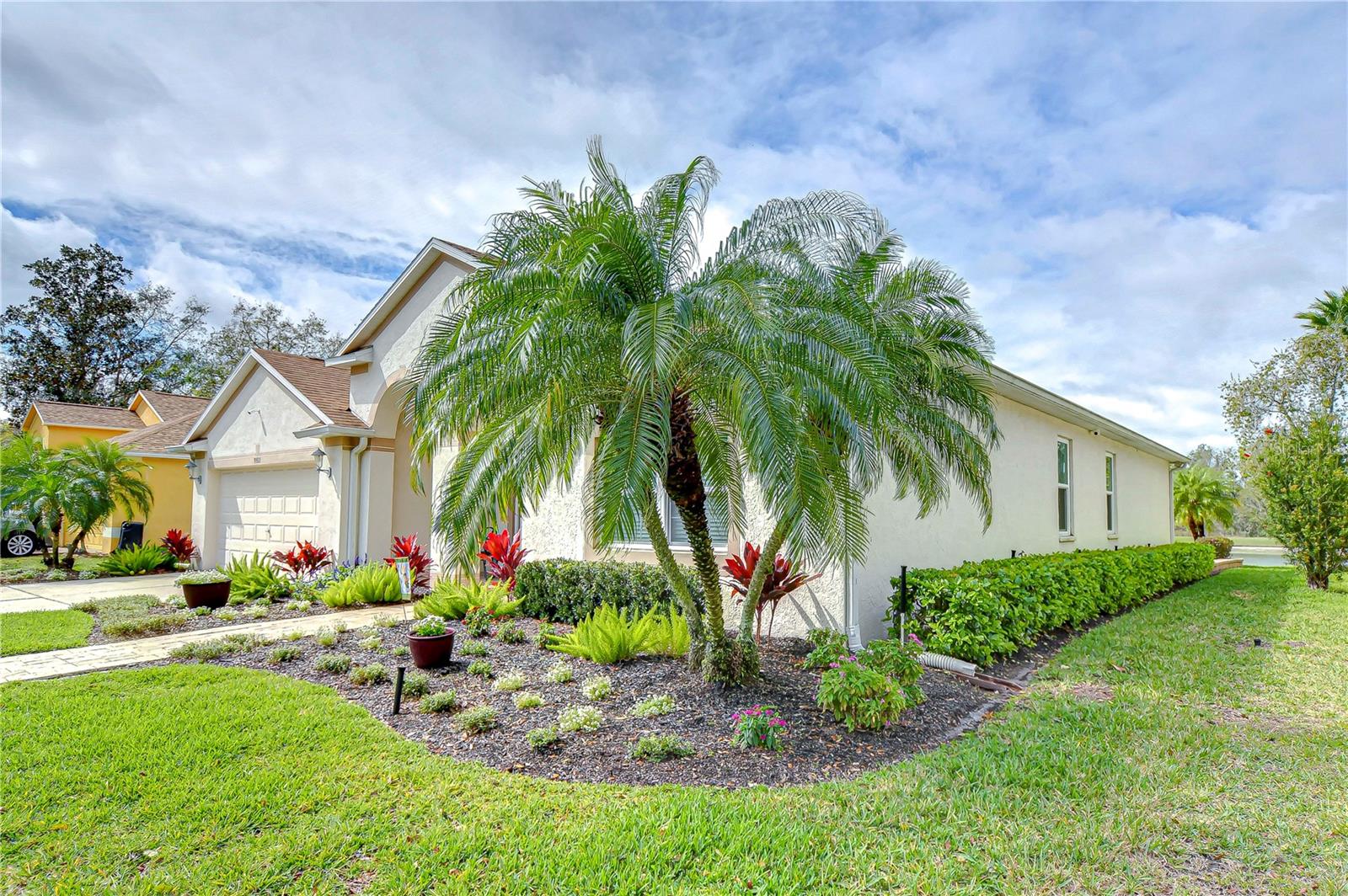 Experience Florida living with this stunning home's tropical landscaping and charming curb appeal.