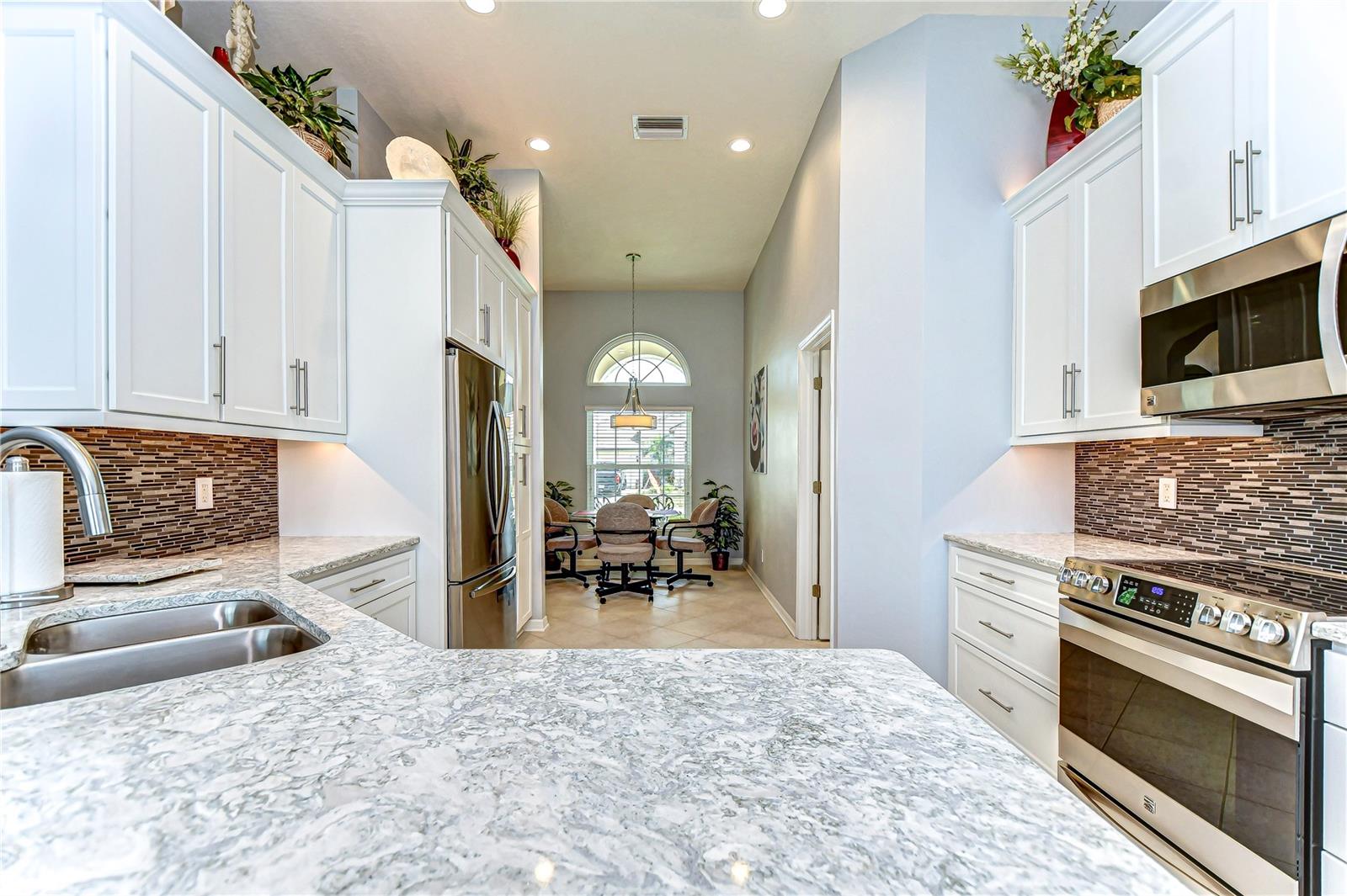 Step into a kitchen that's bright and airy, with sleek countertops and abundant cabinetry.