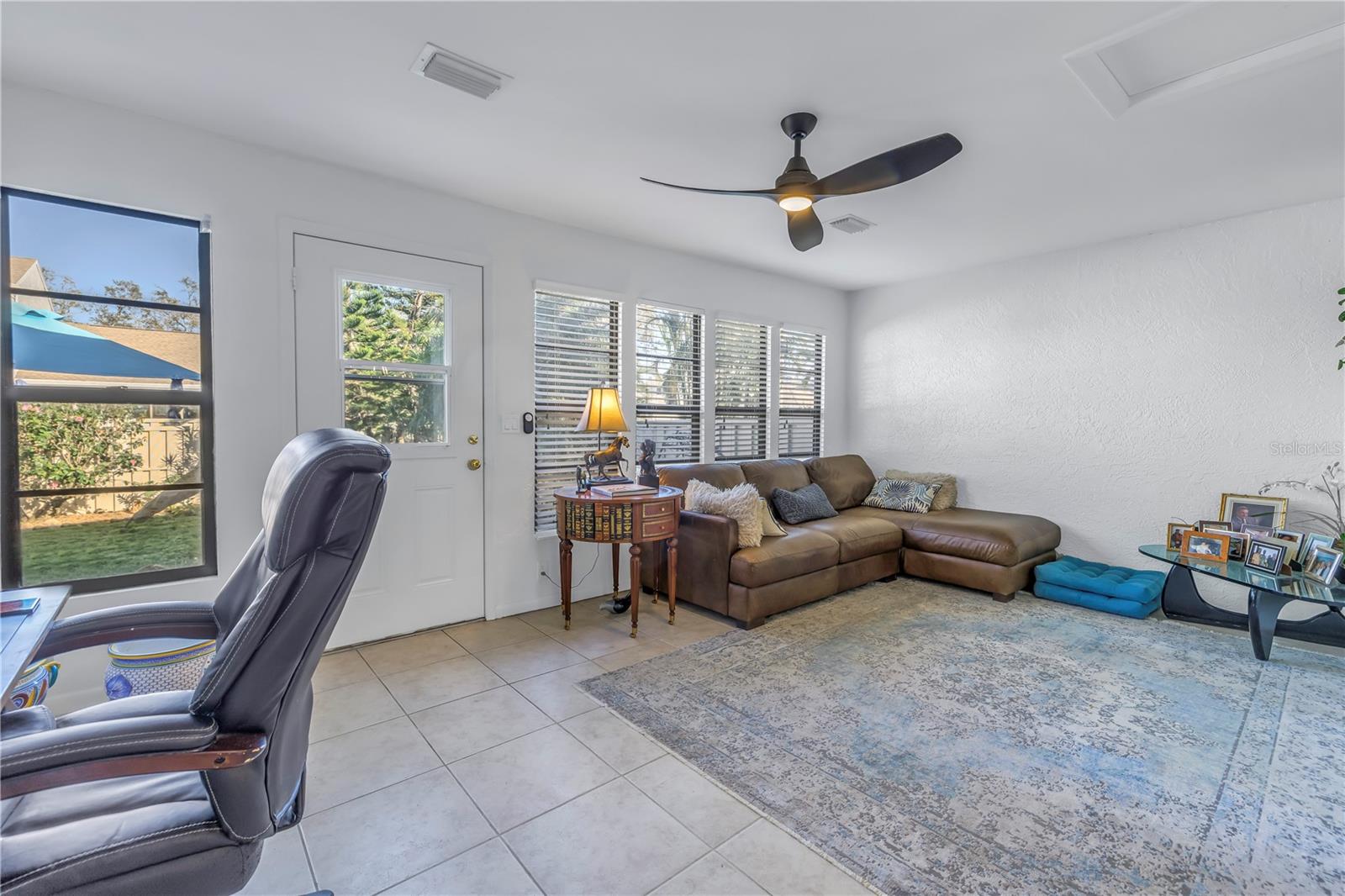 Florida Room is large and accommodates office space, living space and workout space.