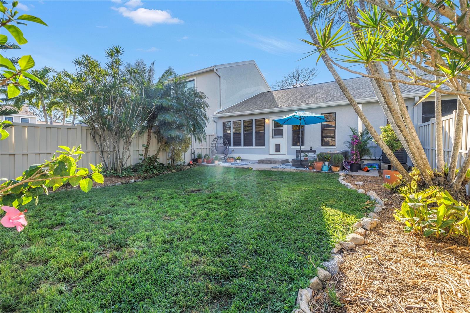 Great beds and plantings featured in the fenced backyard.