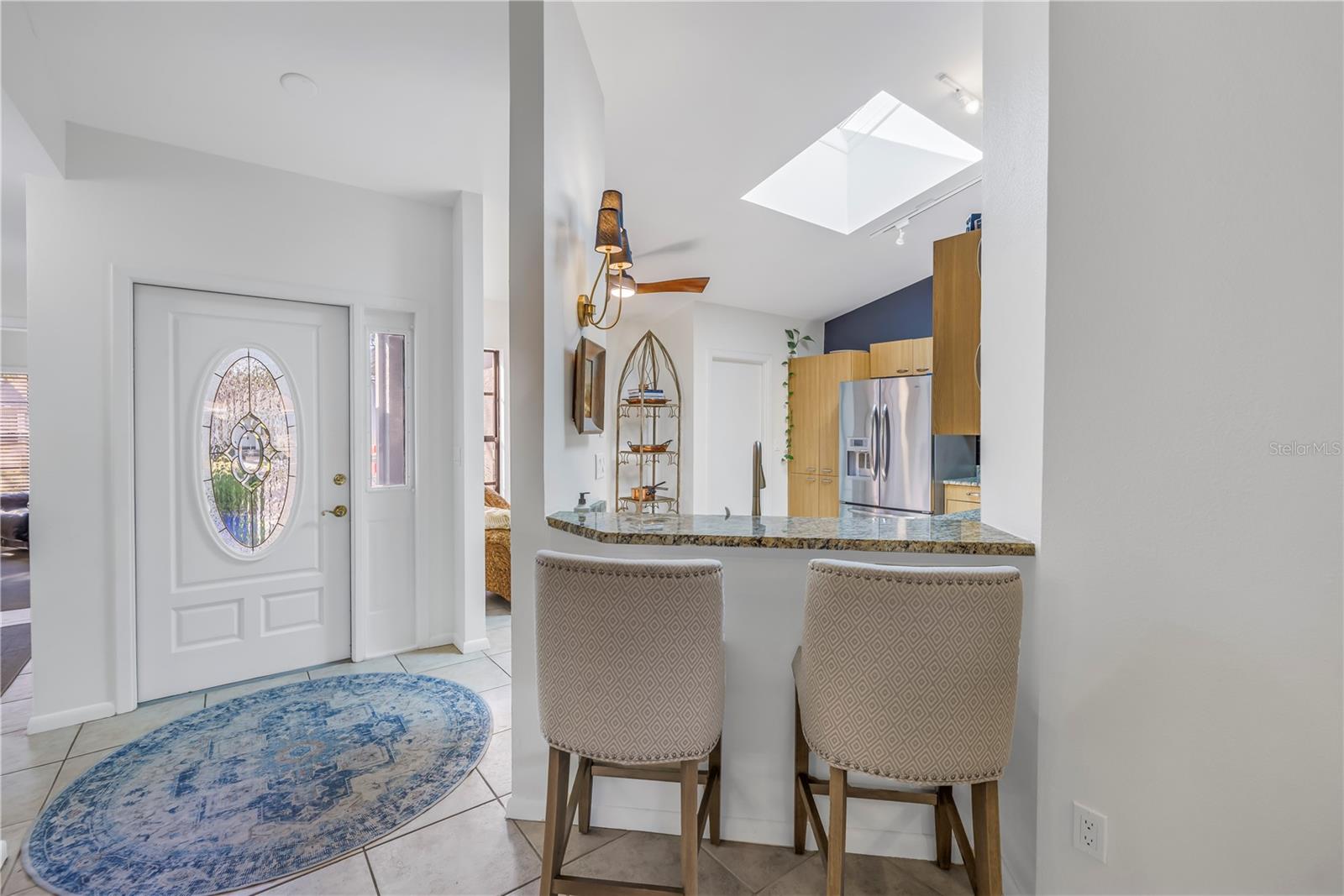 Open Kitchen pass thru with bar and conversational with living and dining areas