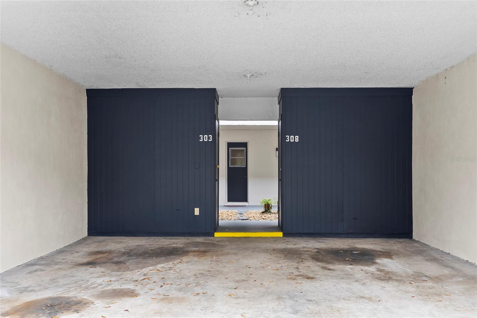 Covered parking spot with storage closet. Unit is directly behind parking spot.