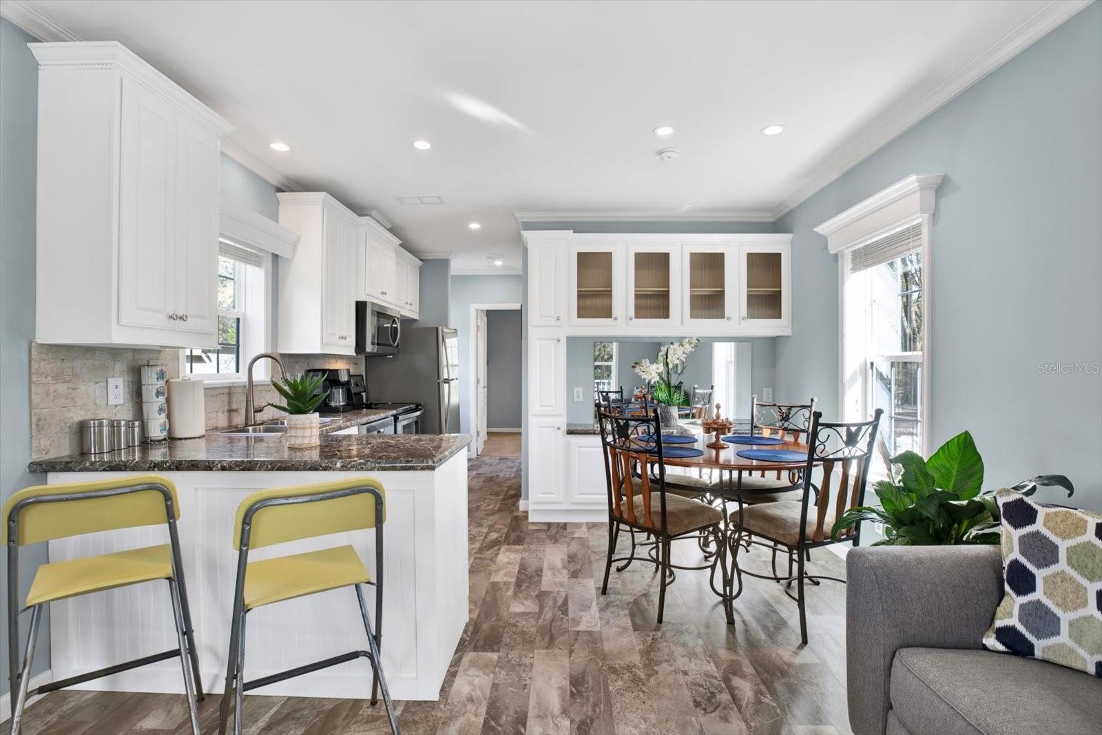 Bar and eating area.Kitchen backsplash & crown molding throughout.