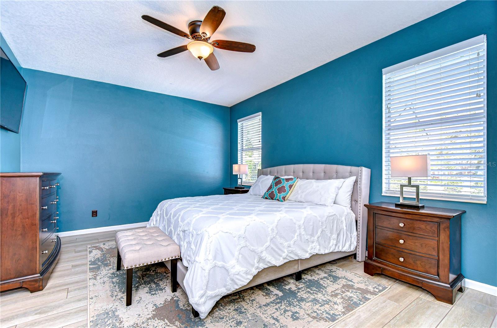 Come into comfort in this vibrant primary bedroom.