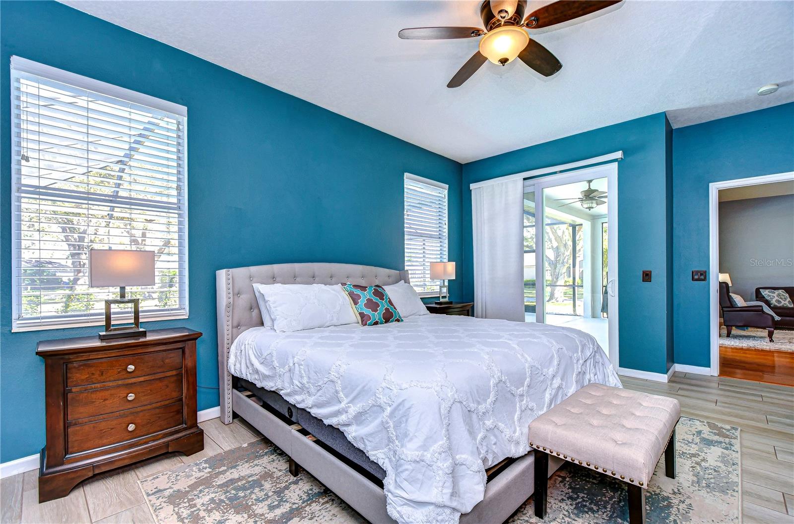 Discover tranquility in the primary bedroom with ample natural light, and easy access to the sun-drenched patio.