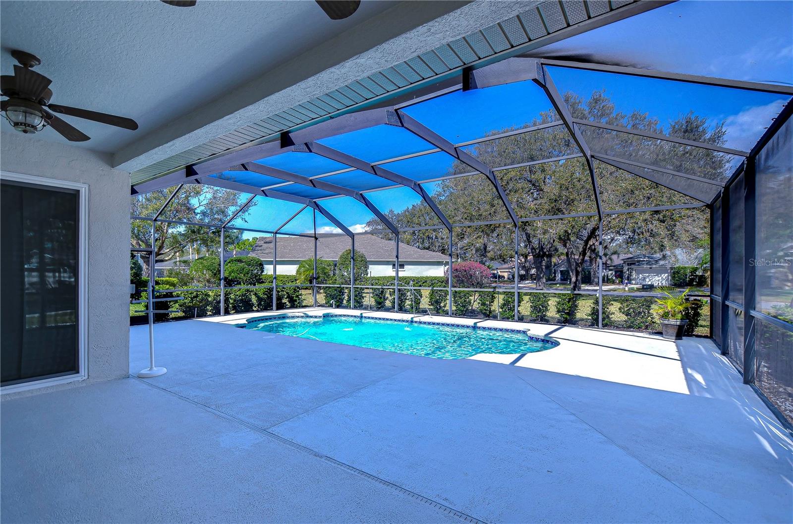 Relax and unwind in your private oasis featuring a sparkling screened pool.