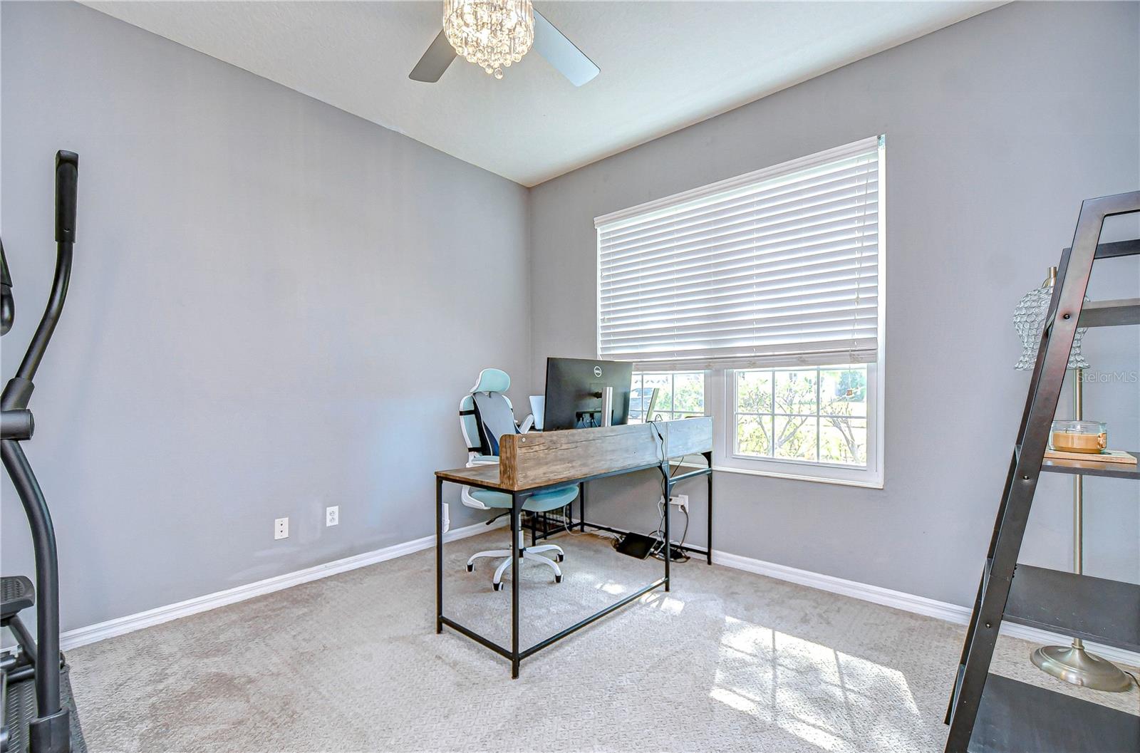 This large flex space can be a playroom, office, or formal living area!