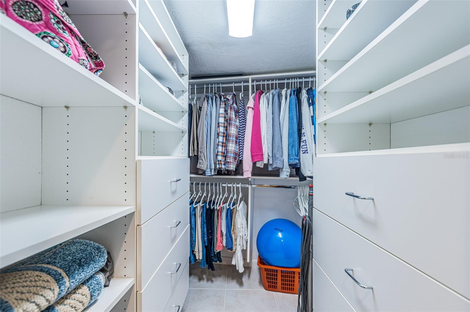 Ensuite bedroom has a walk in closet with built in shelves and drawers