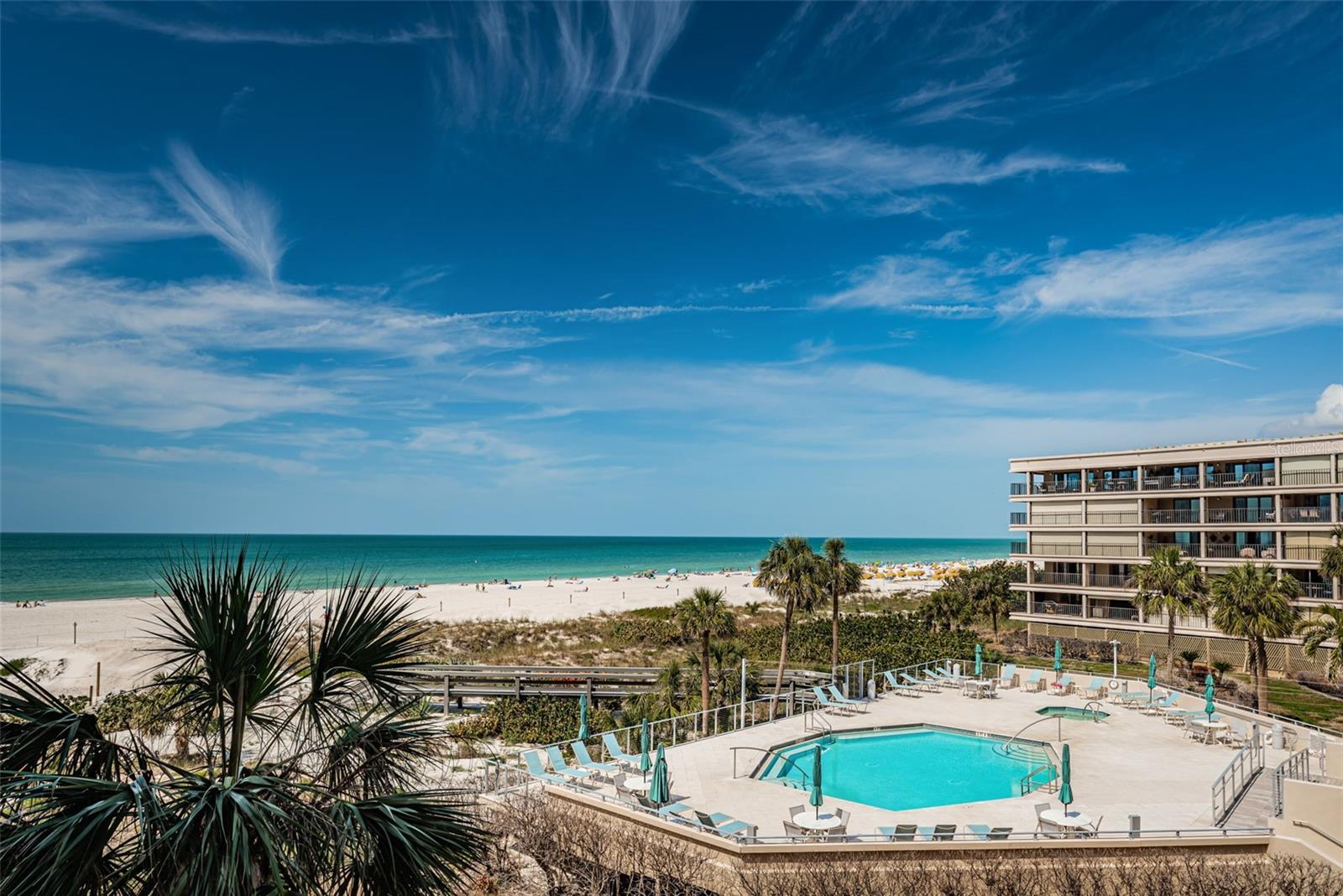 View of the beach and the pool from the balcony of 303.