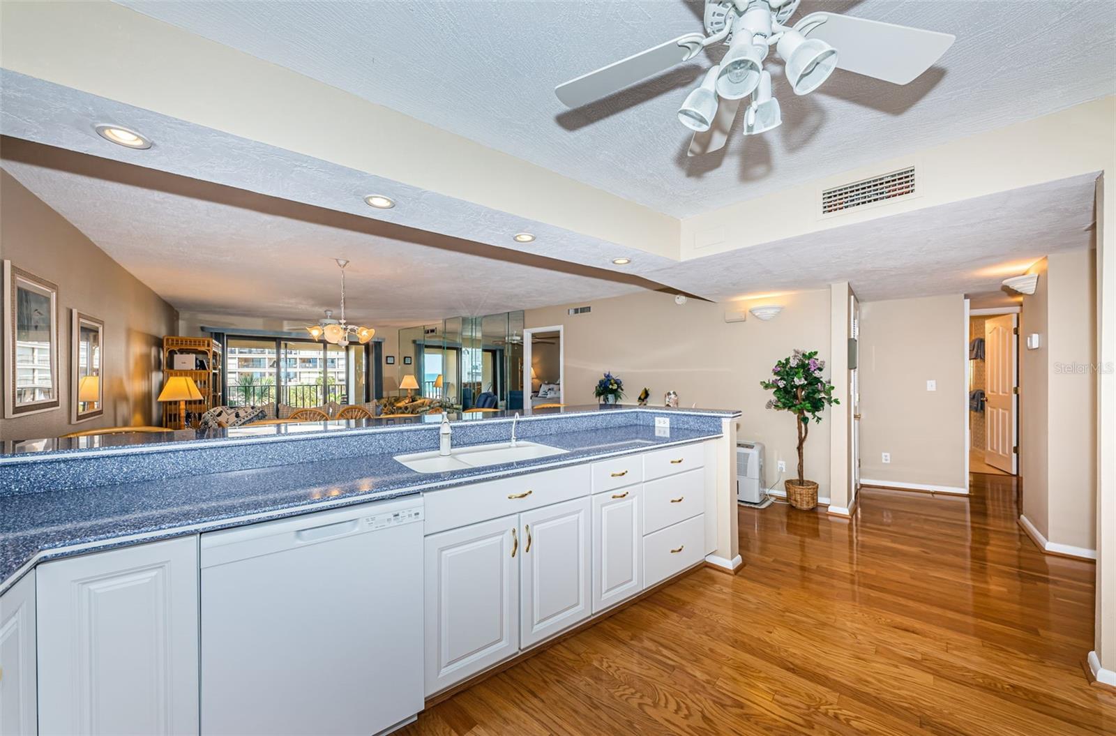 A view of the kitchen towards the hall to the spacious second bedroom and second bath