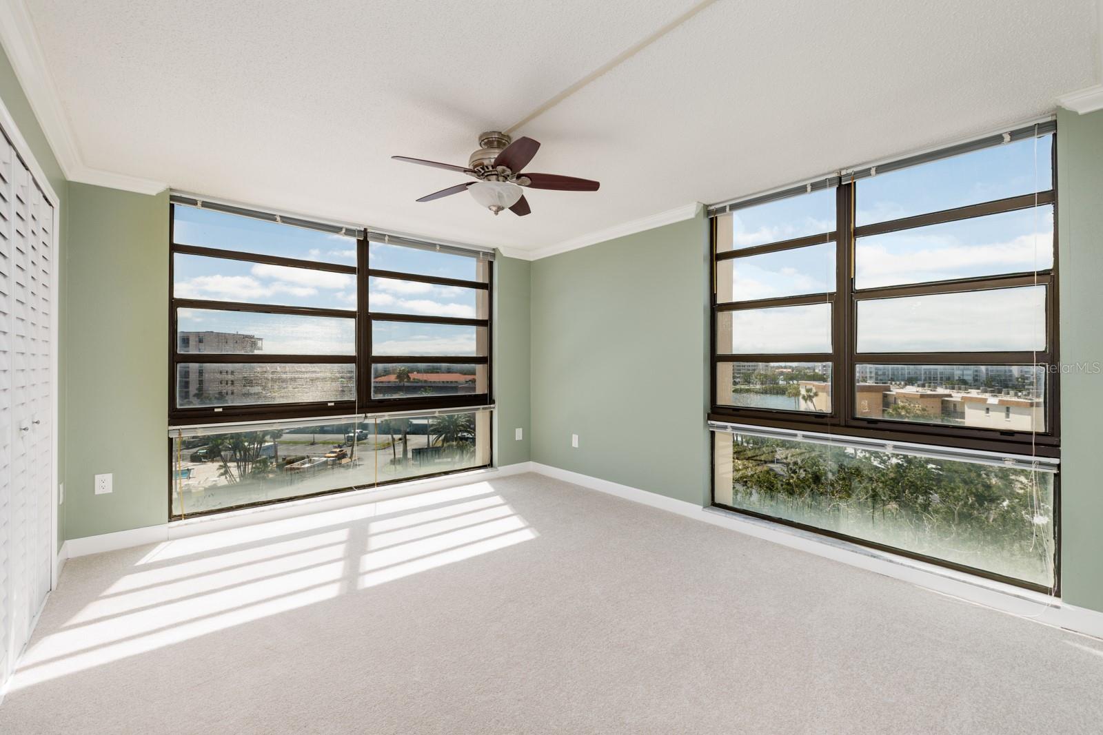 Second Bedroom with 2 oversize closets & floor  to ceiling windows with views of  the bay, the intracoastal, peek a boo view of the Gulf & more!