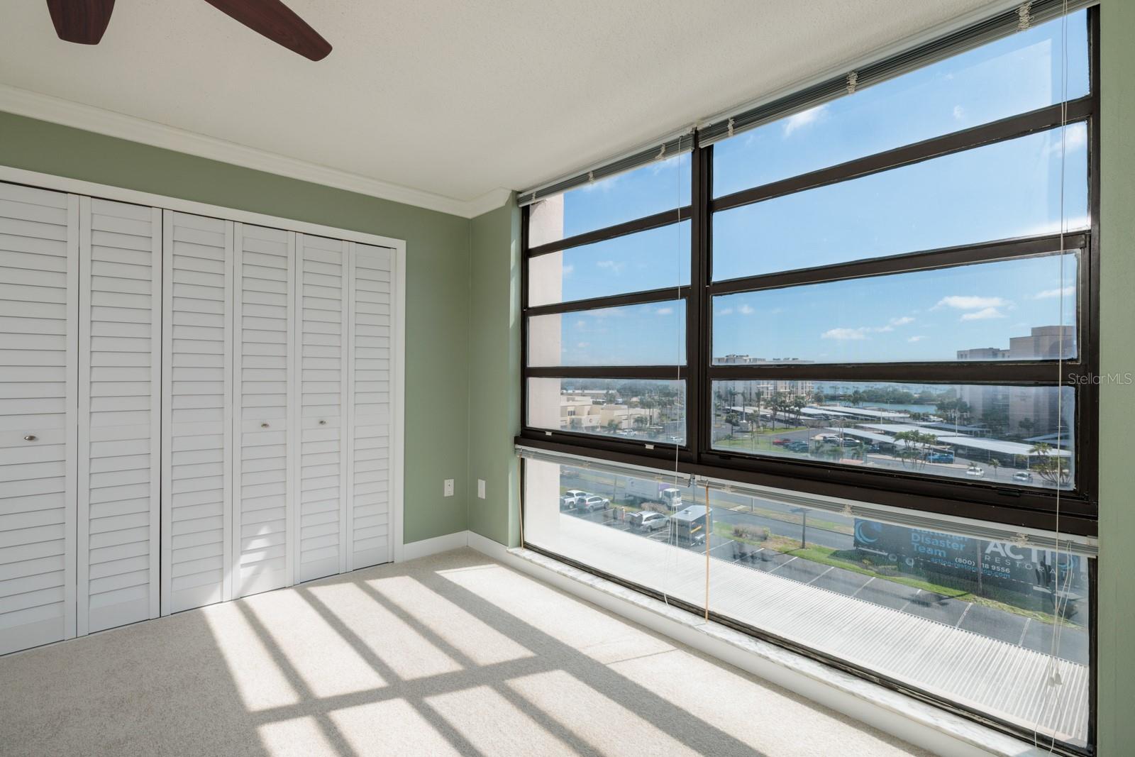 Second Bedroom with 2 oversize closets & floor  to ceiling windows with views of  the bay, the intracoastal, peek a boo view of the Gulf & more!