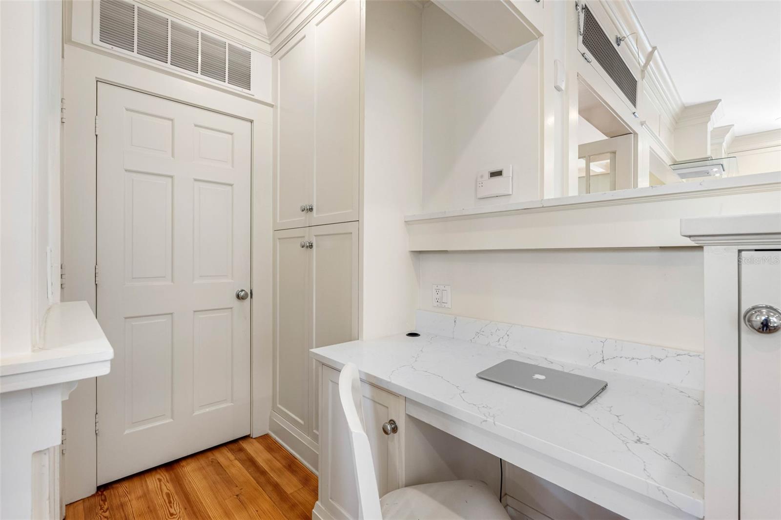 Desk in eat-in breakfast area. The door accesses a big pantry/storage.