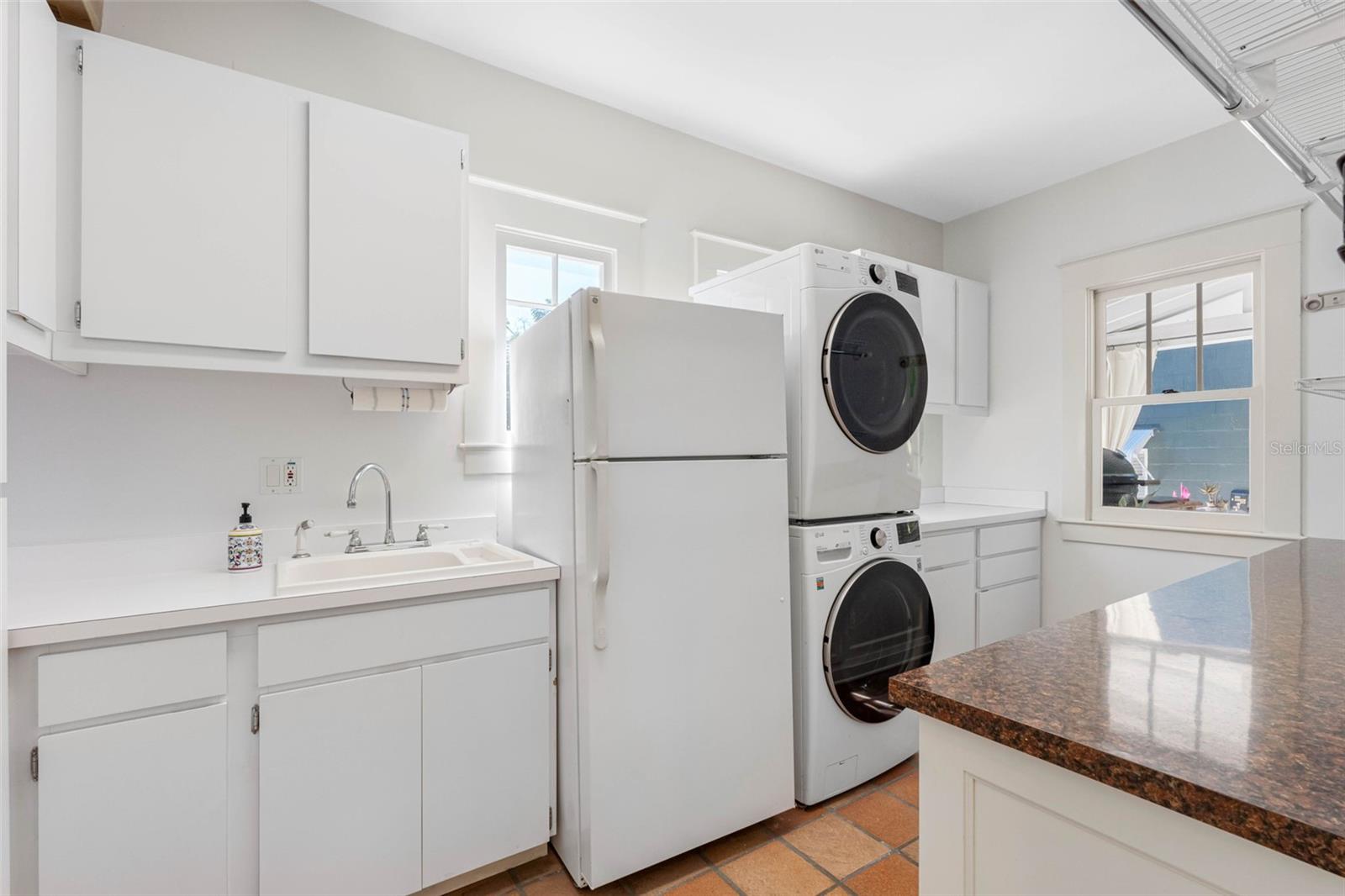 Large laundry room with LG washer and dryer (3 years old) and an adittional refrigerator.