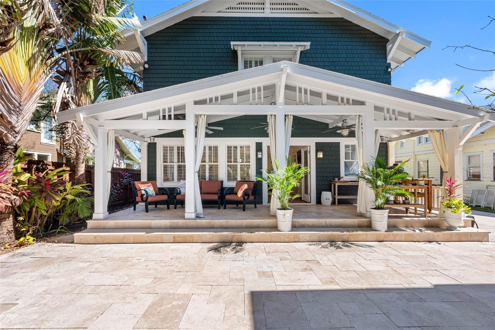 Back lanai with travertine pavers.