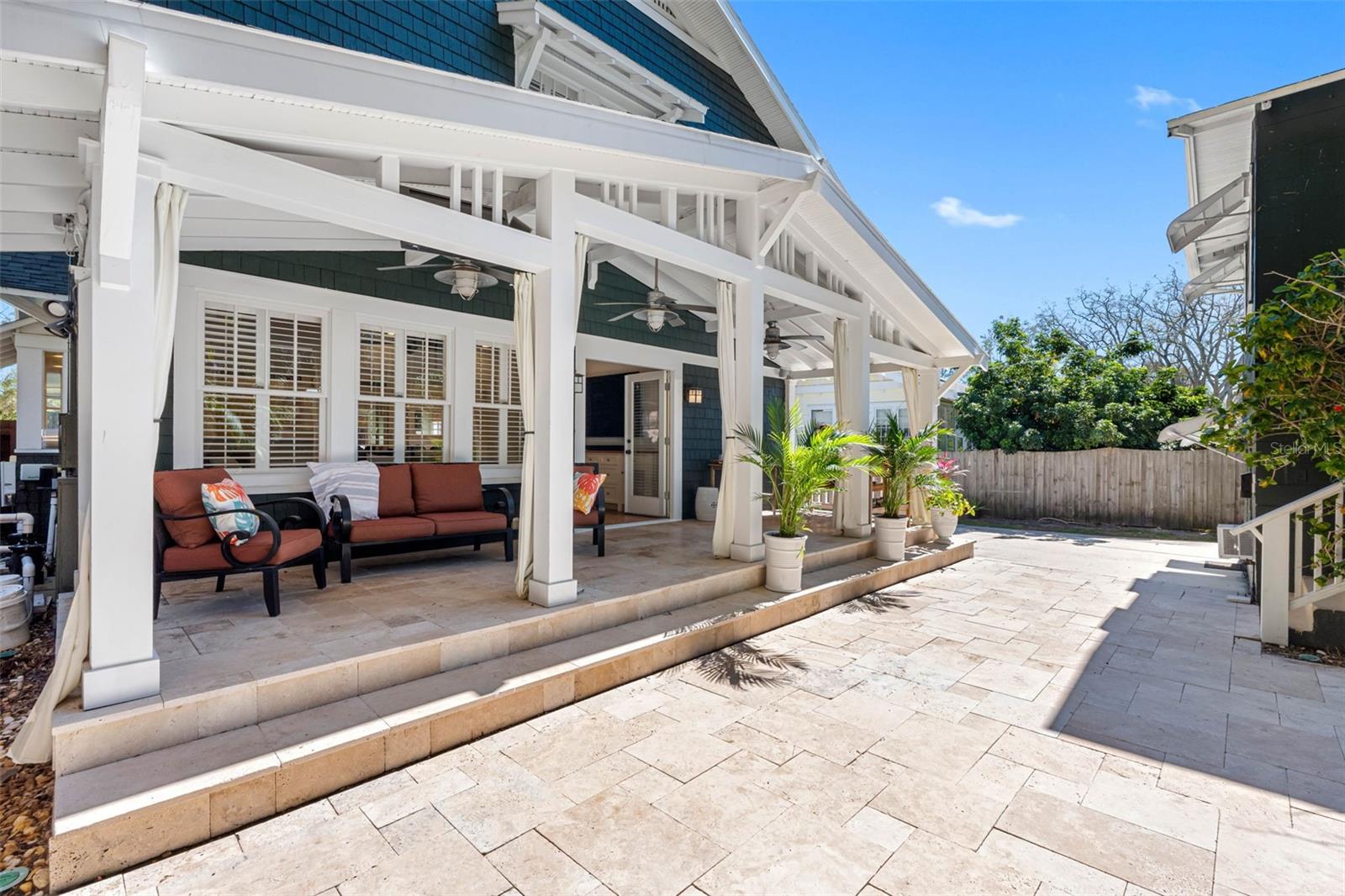 Back lanai with heated cocktail pool/spa and travertine pavers.