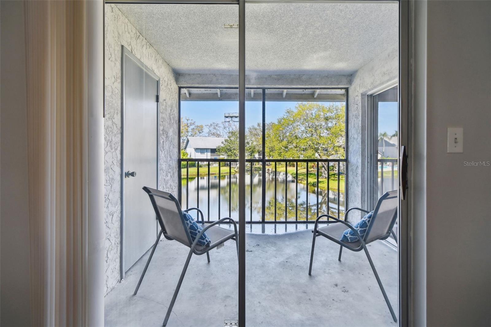 view from living room. Storage closet to left and primary bedroom sliding glass doors to right