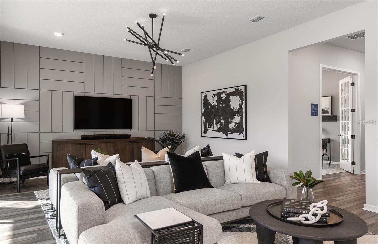 Model representation of Living area looking towards flex space