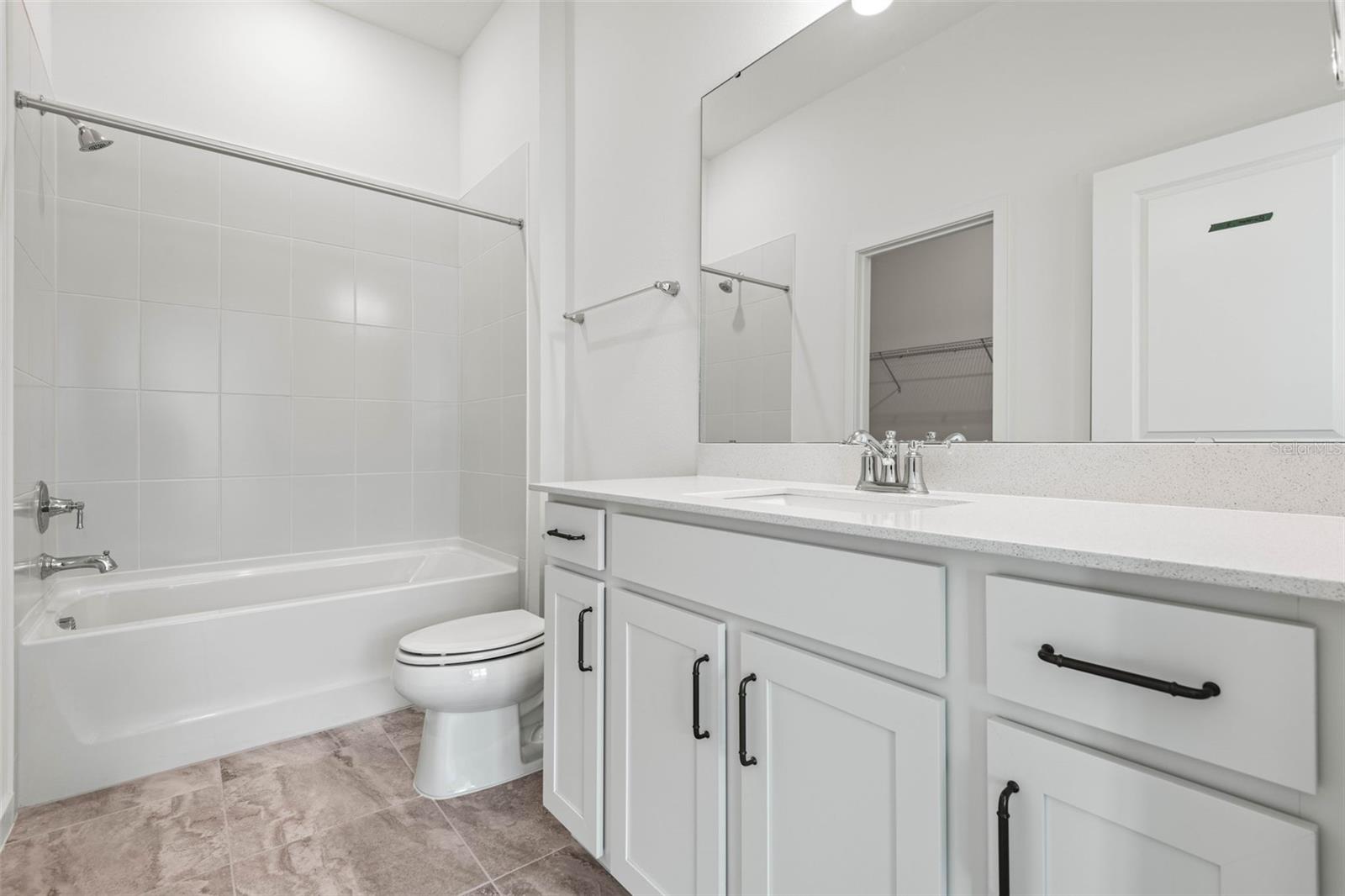 Downstairs en suite bathroom to secondary bedroom. Also features a walk in closet.