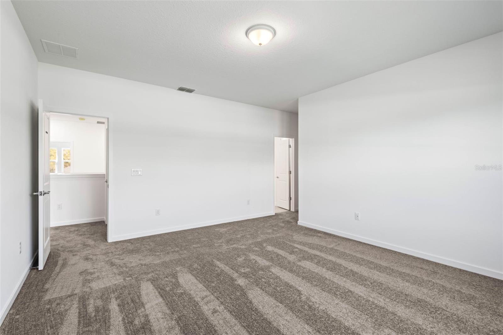 Primary bedroom with en suite bathroom and walk in closet
