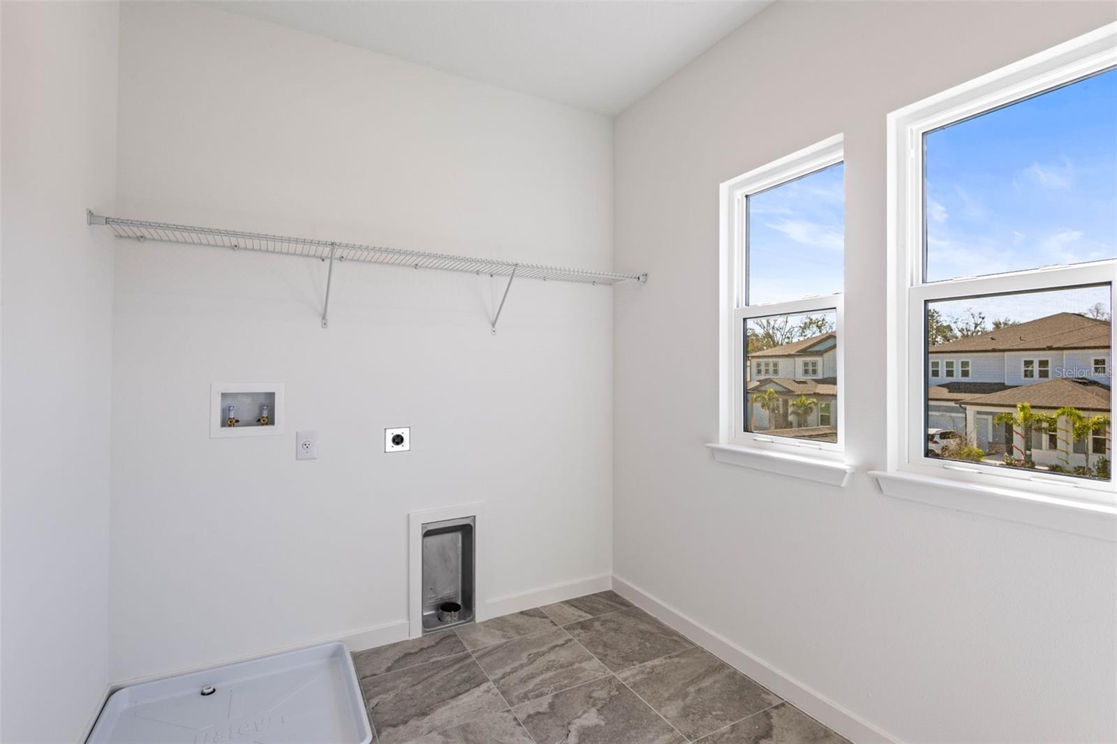 Laundry room upstairs with large closet to store linens and supplies