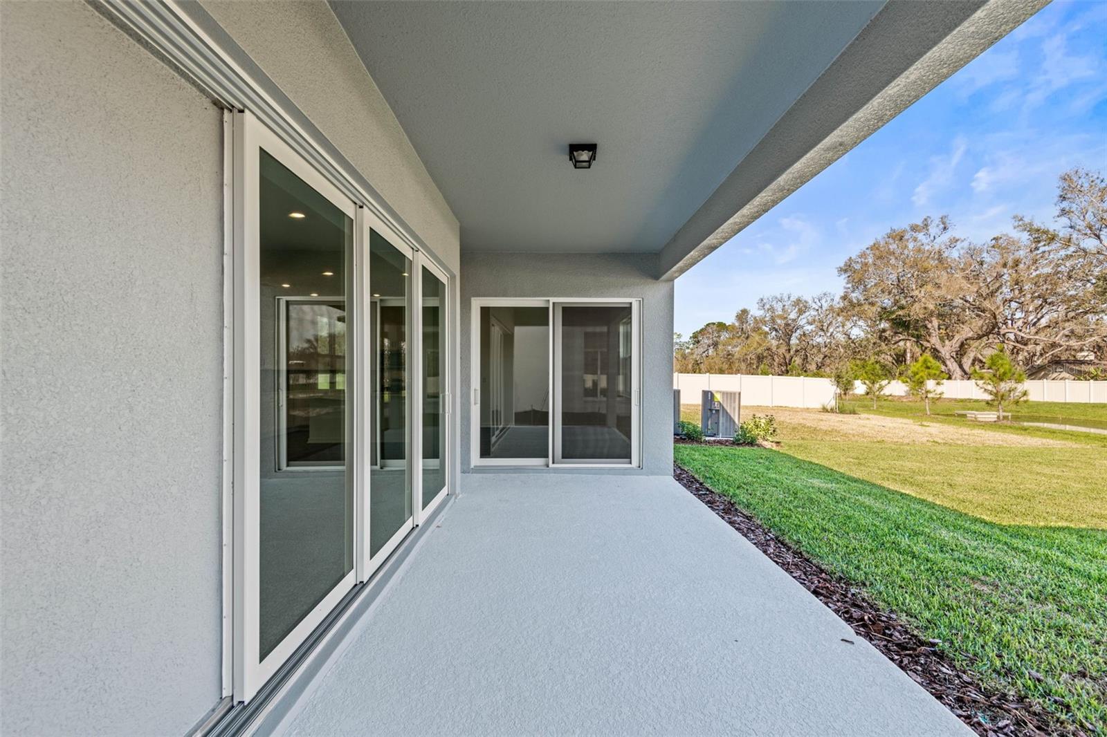 Triple pocket sliding glass doors off of main living area and regular sliding glass doors off of the dining area provide access to the large, covered lanai overlooking the pond.
